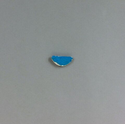 Blue Ceramic Fragment on Gray Background