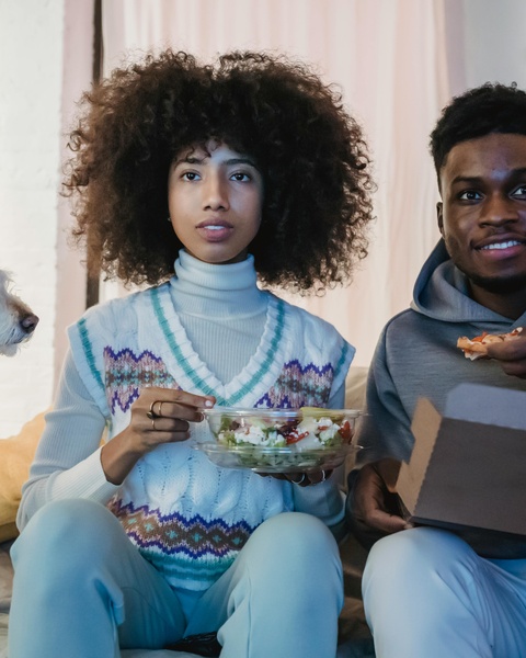Two People Eating Takeout at Home