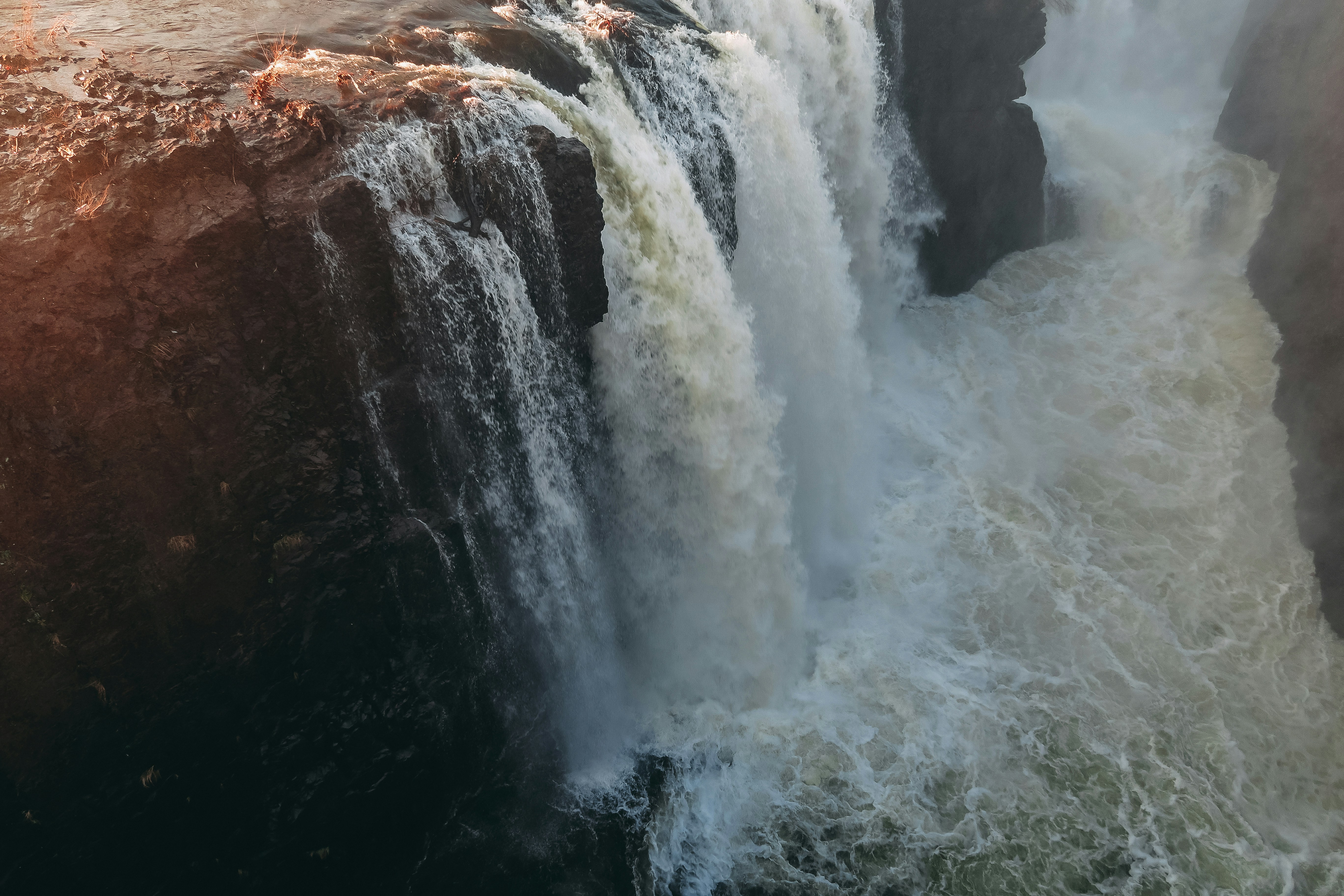 Turbulent Waterfall Over Dark Cliffs