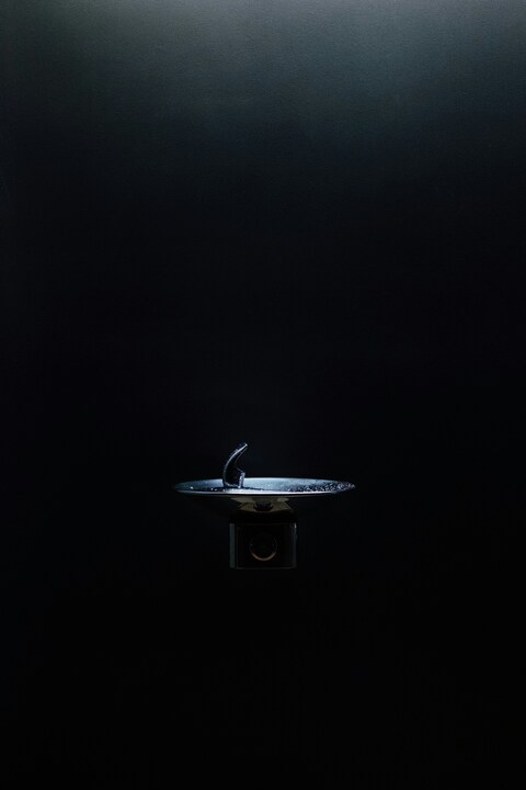 Modern Faucet Against Dark Background