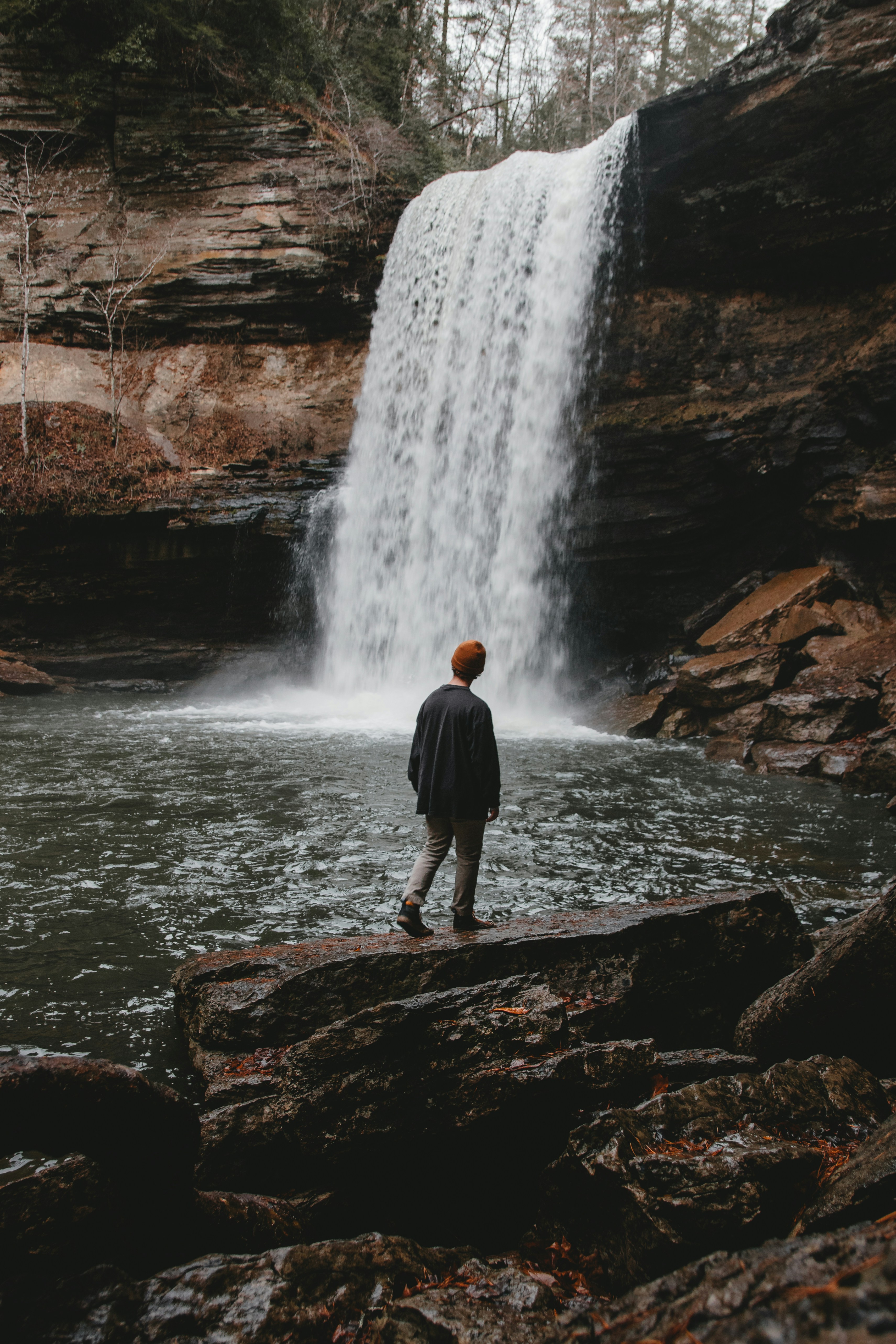 Hiker Standing Before Waterfall