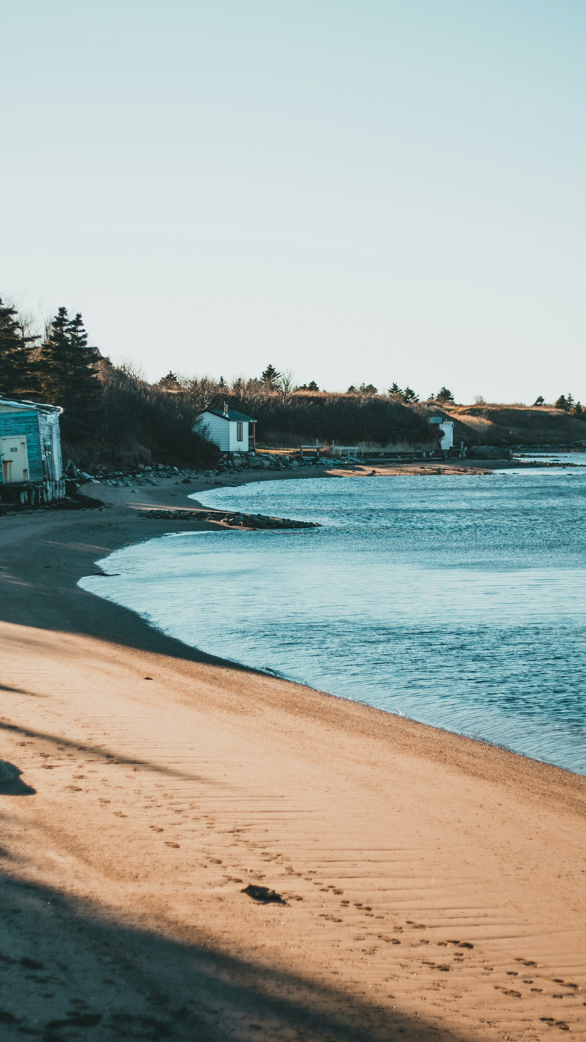 Quiet Coastal Beach with Footprints