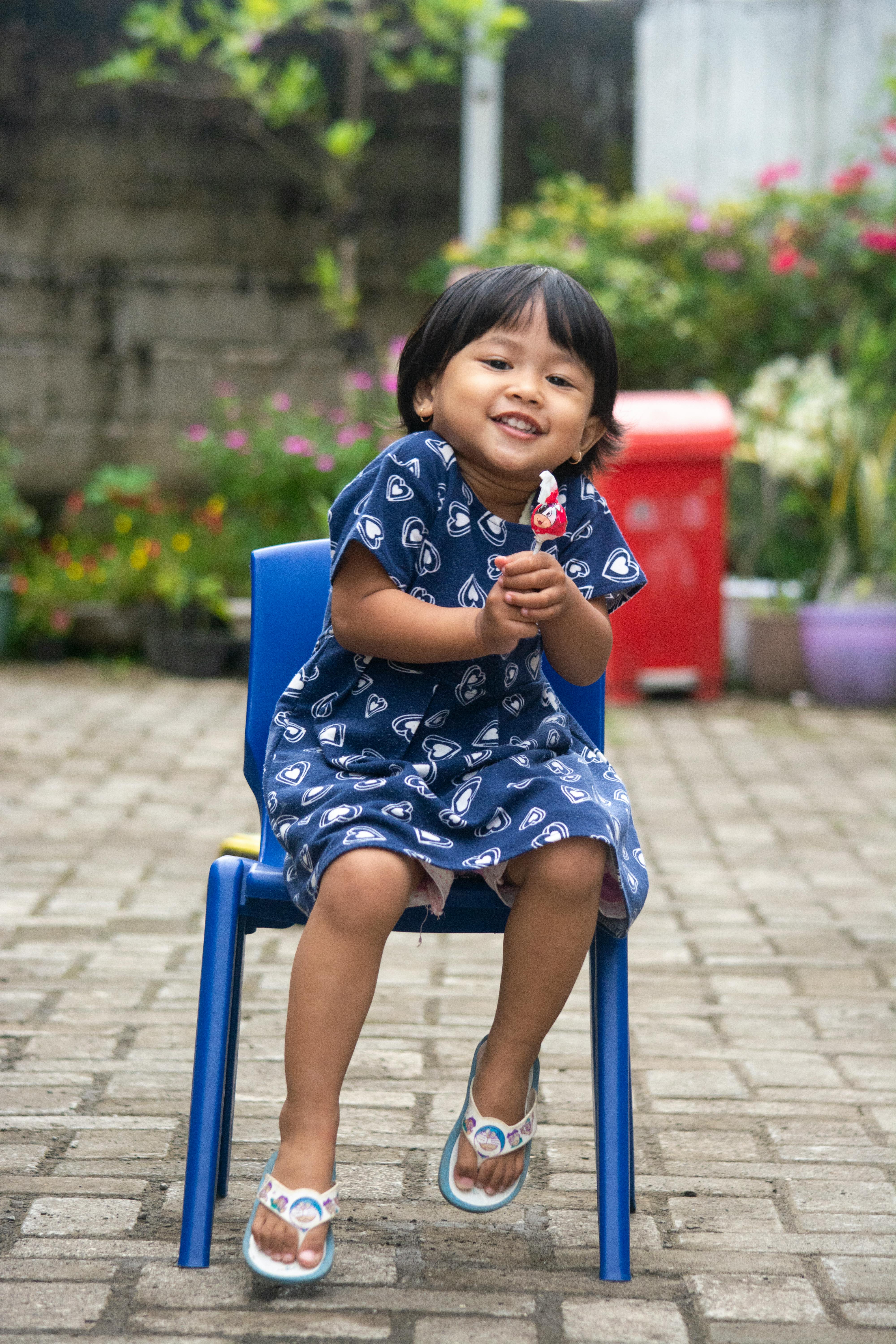 Smiling Little Girl Holding Lollipop