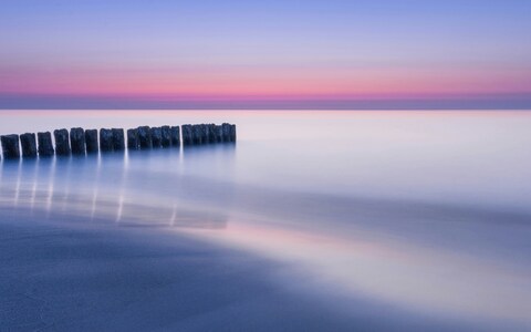 Calm Sea at Dusk with Old Groynes