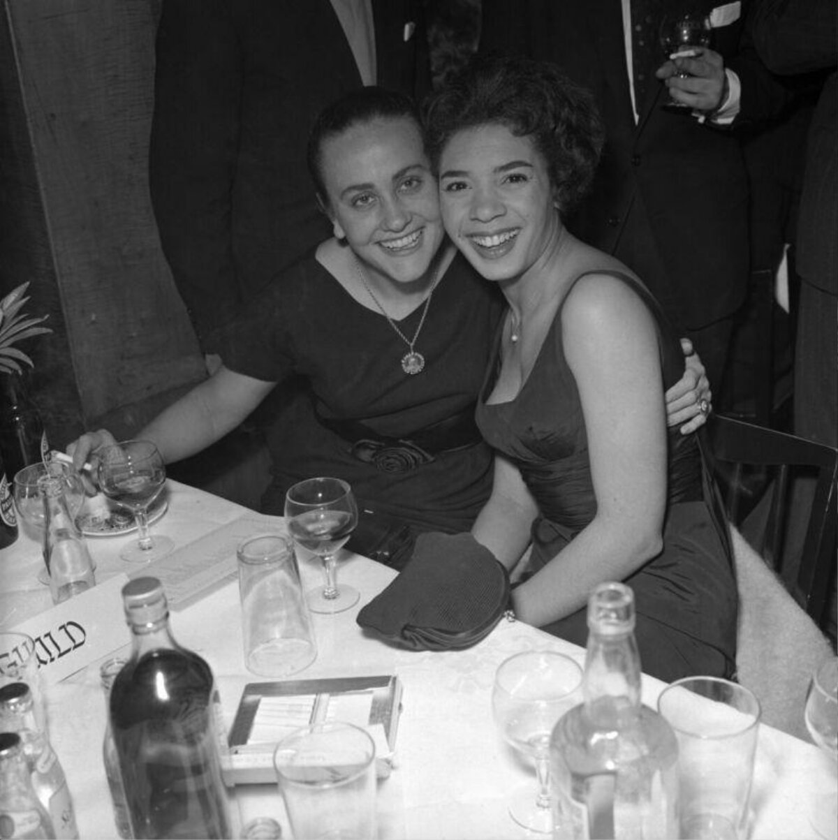 Two Smiling Women at Dinner Table
