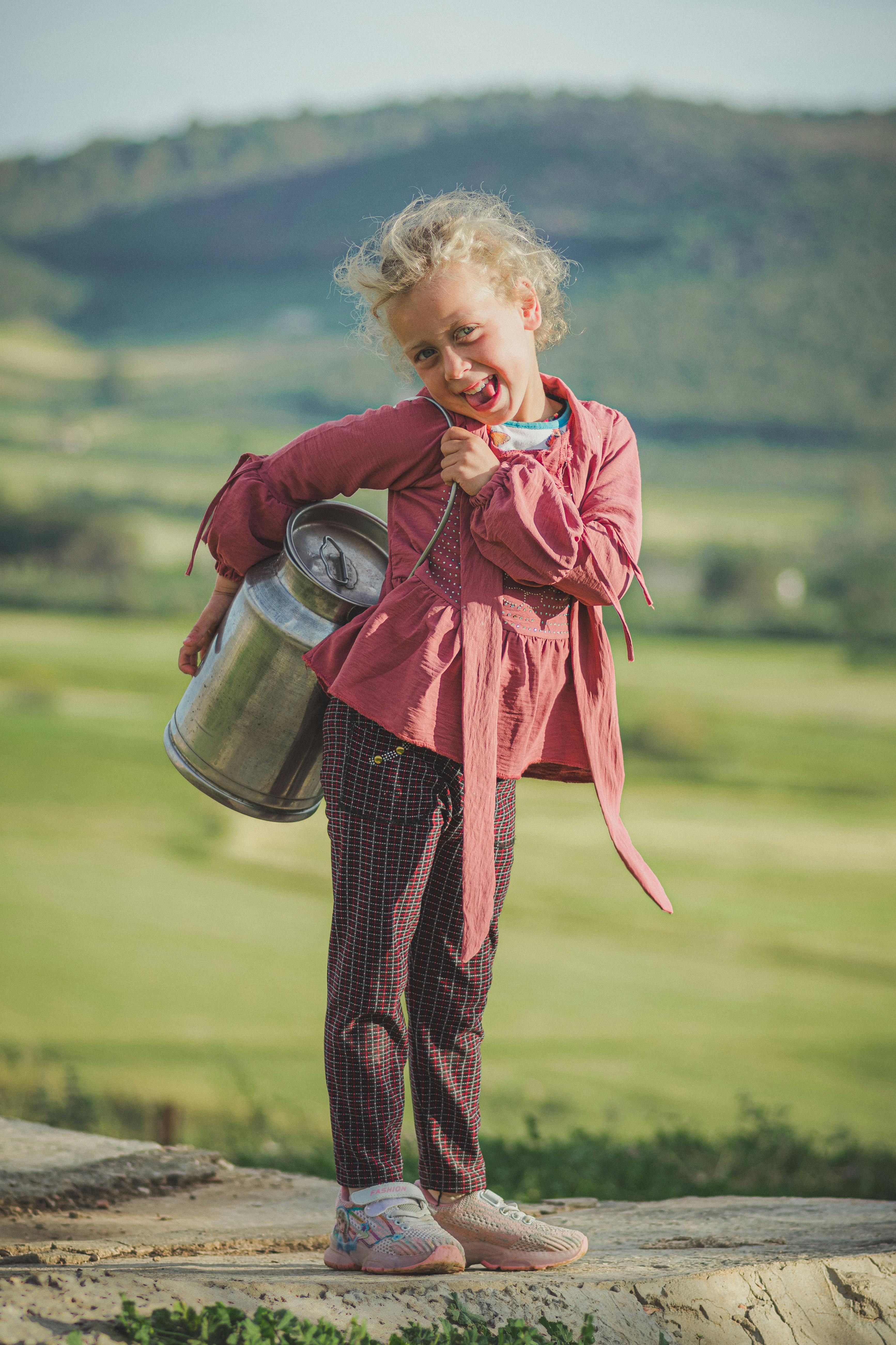 Little Girl Carrying Metal Milk Can