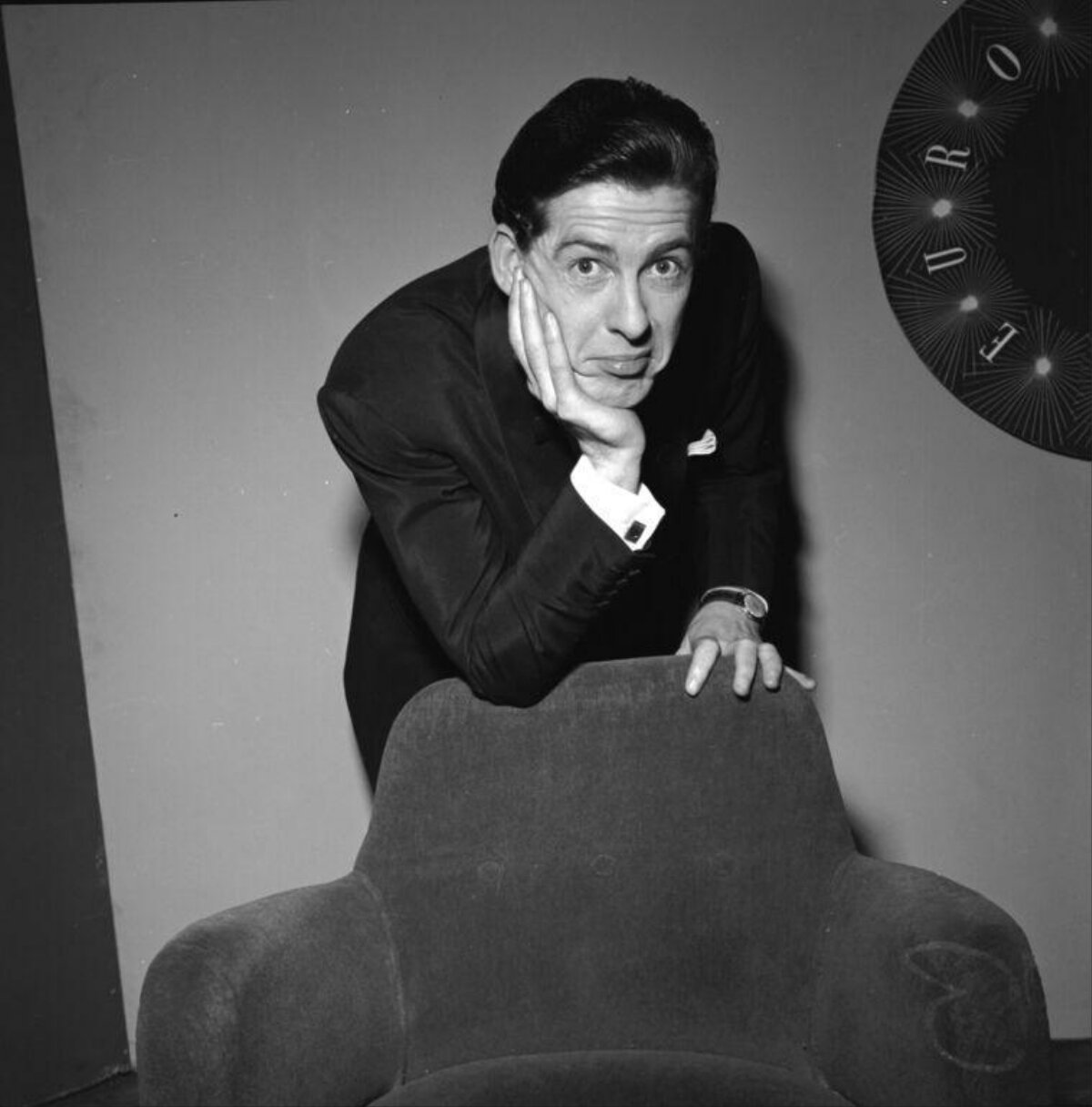 Comedic Portrait of Man Leaning on Armchair