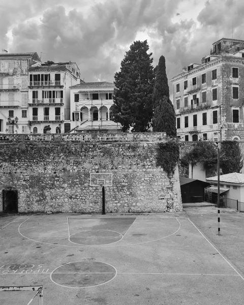 Outdoor Basketball Court Below Old Town Buildings
