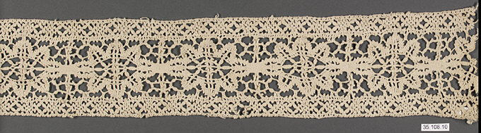 Crocheted lace strip on gray background