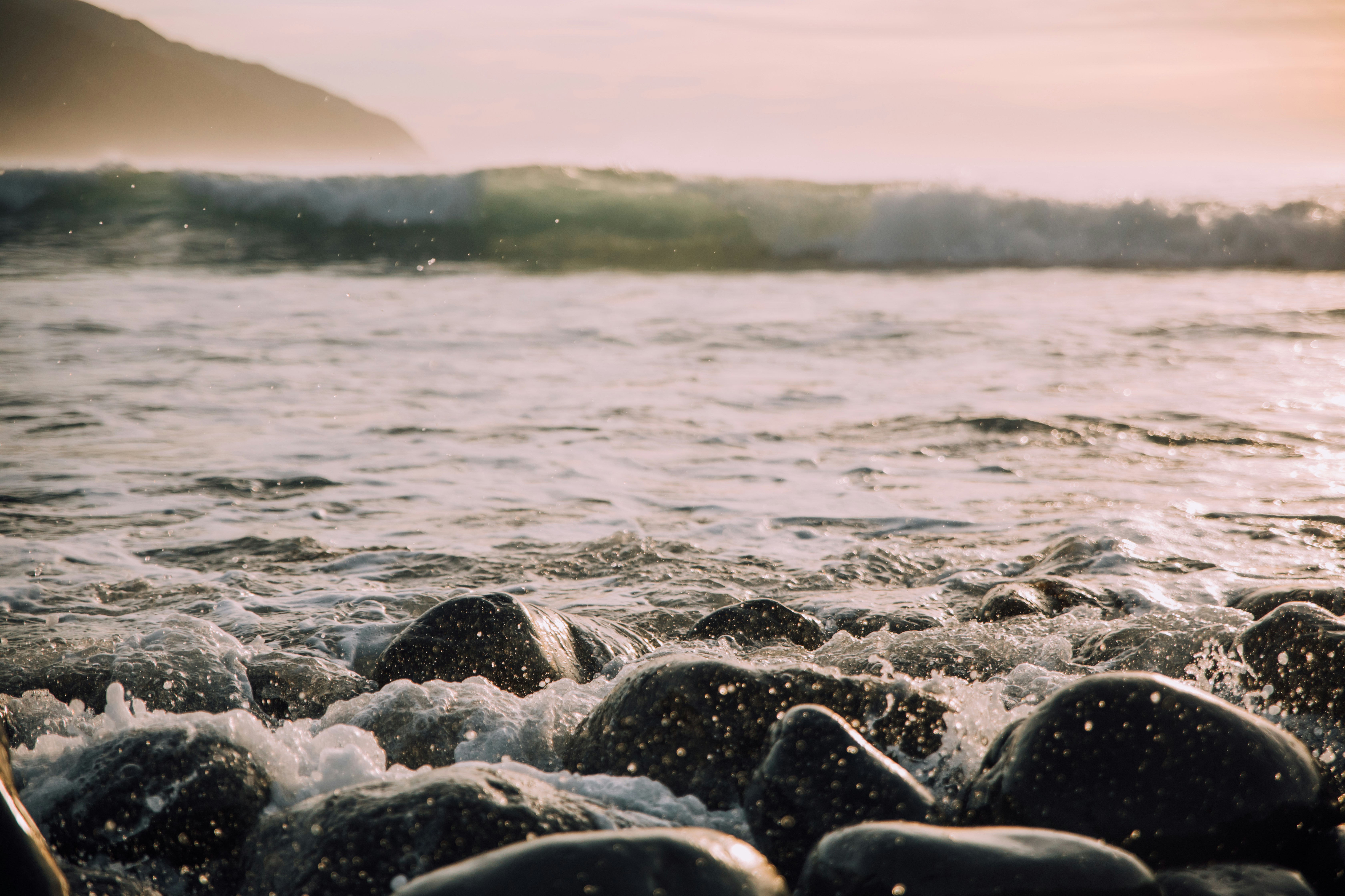 Sunlit Coastal Waves on Shore Stones — Scenery