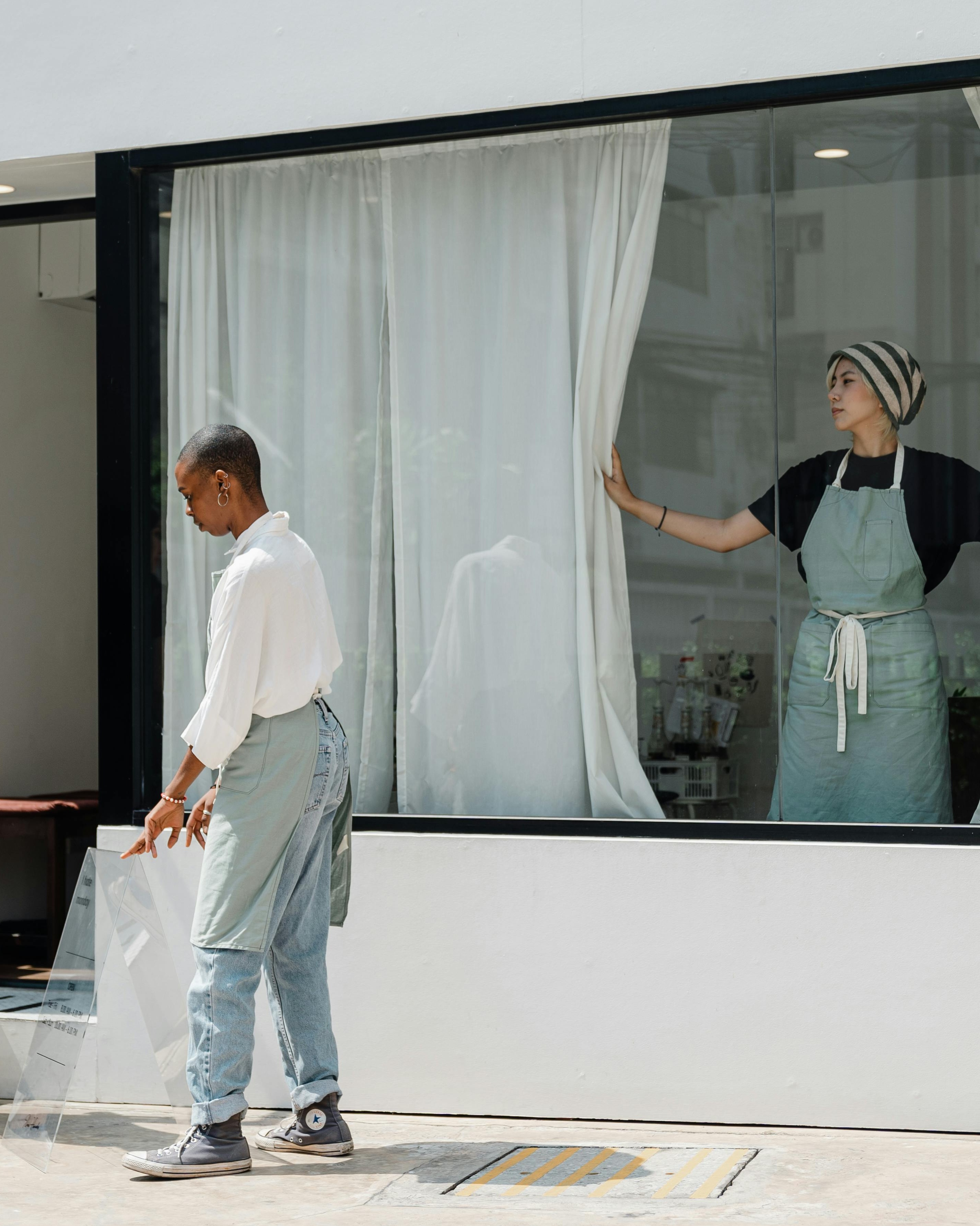 Two Shop Staff Arranging Storefront