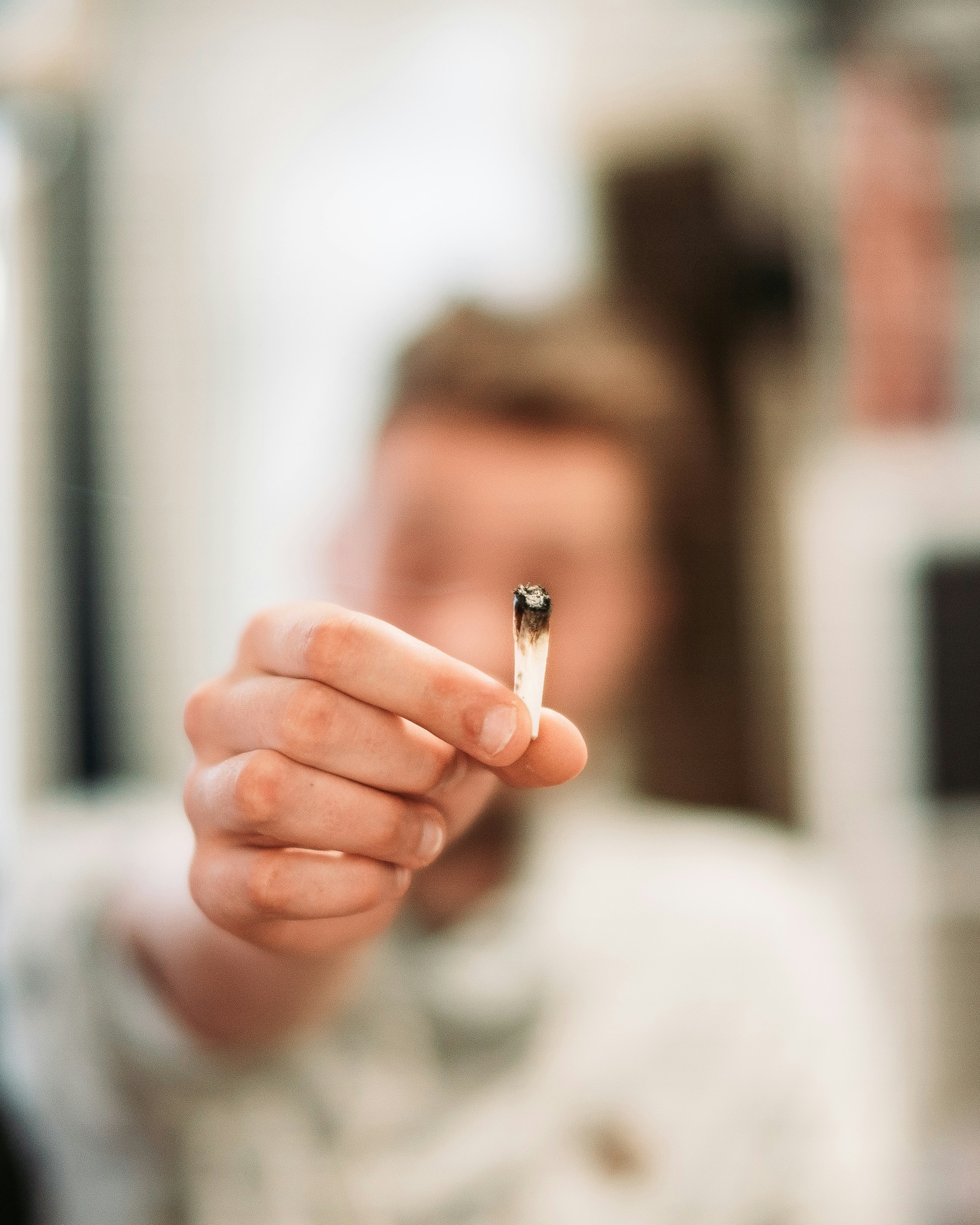 Hand Holding Smoked Cannabis Joint