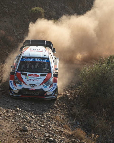 Rally Car on Dusty Gravel Road