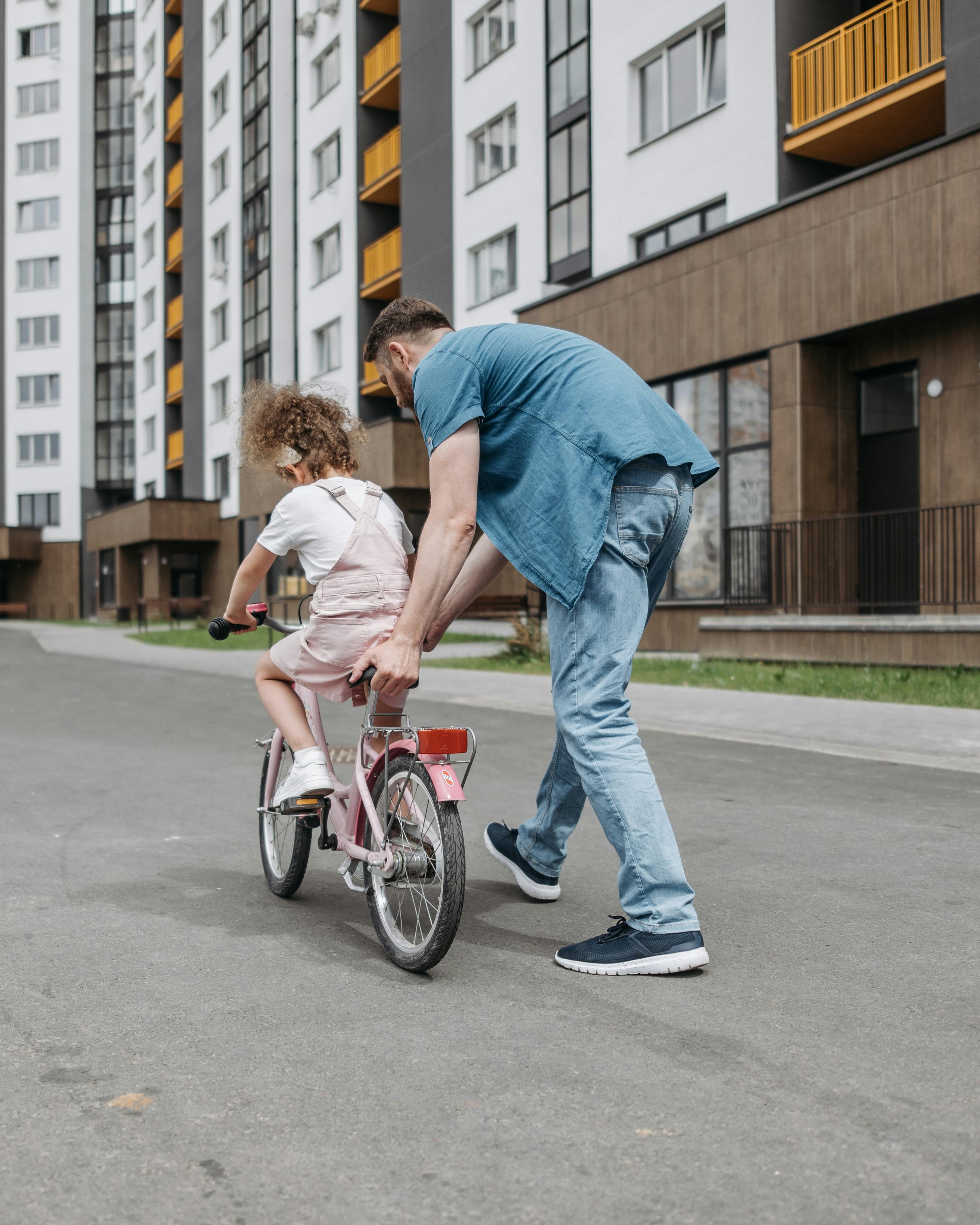 Father Teaches Daughter to Ride Bicycle