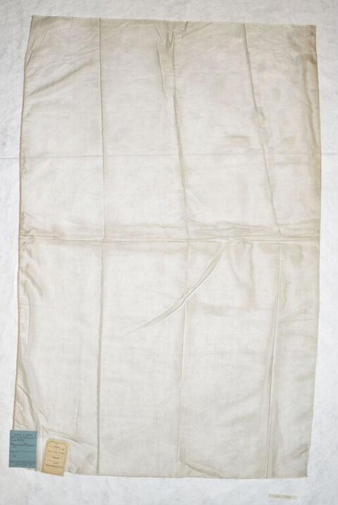 Folded Off-white Cloth With Attached Tags
