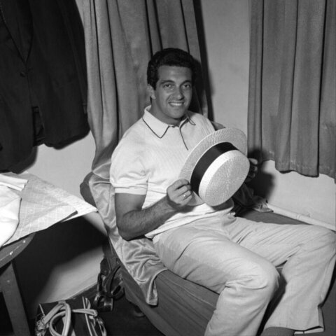 Smiling Man Holding a Straw Hat