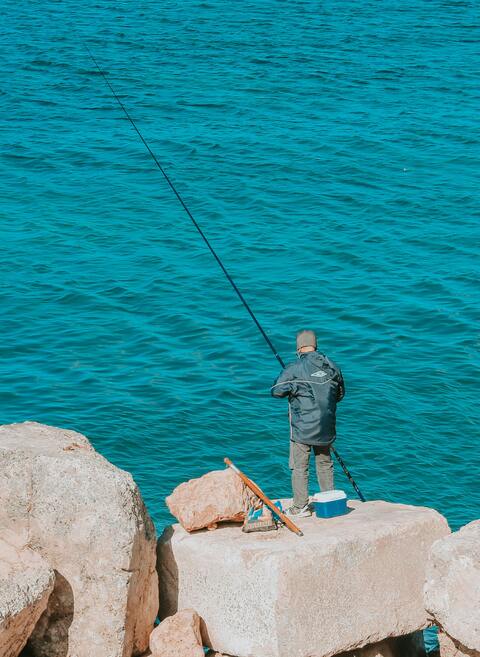 Fisherman Fishing by the Sea