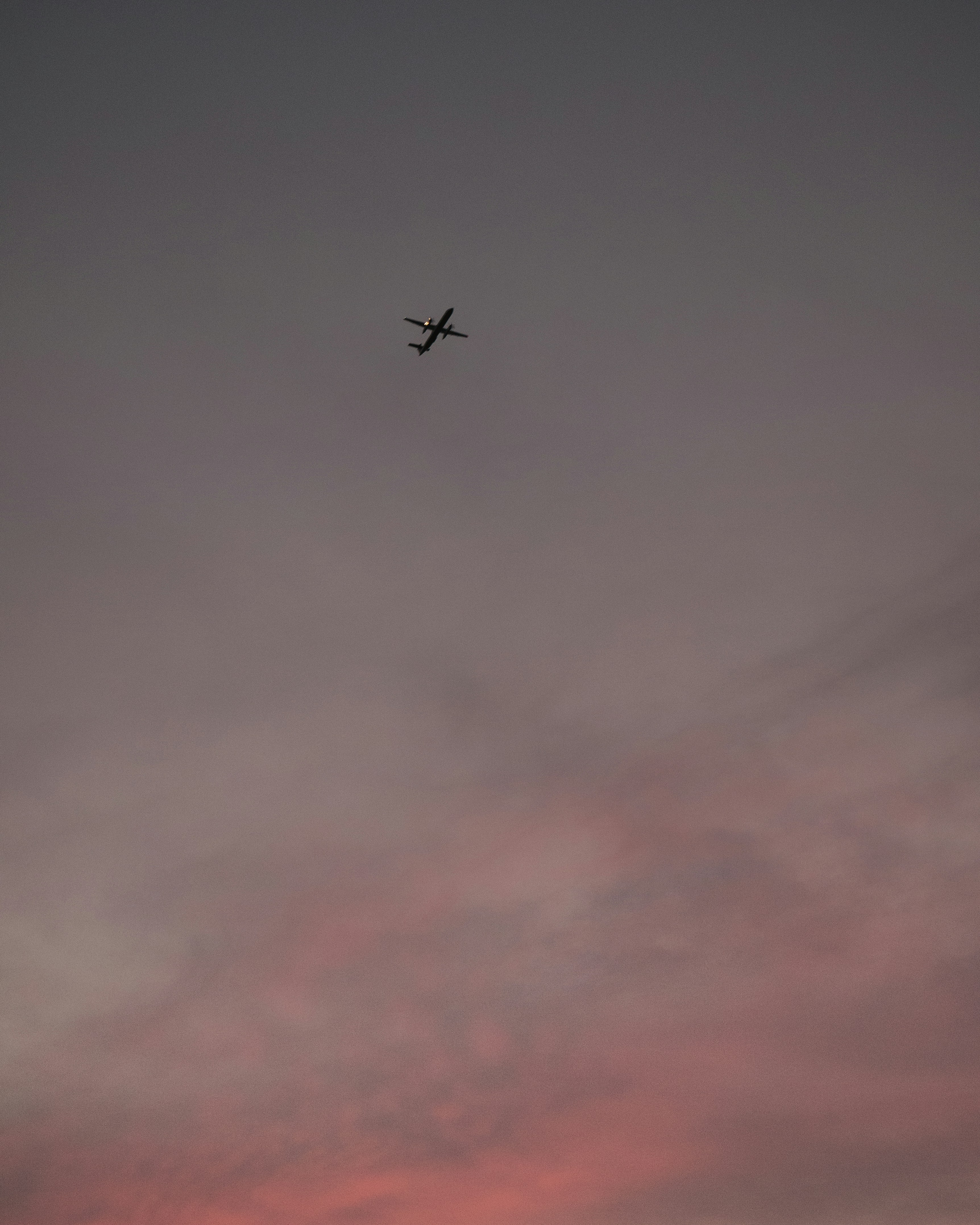 Airplane Against Dusk Pink Sky