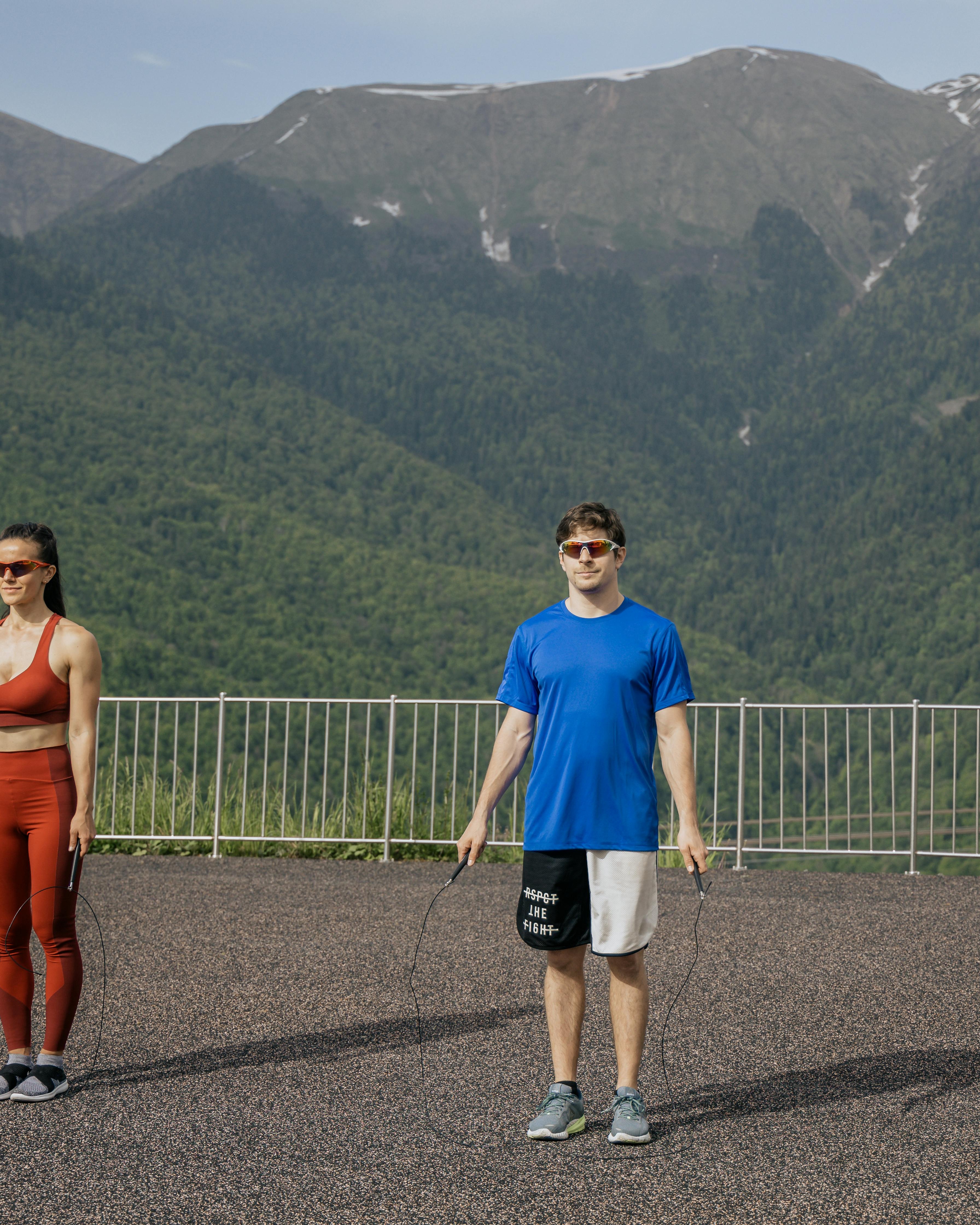 Two People Ready to Jump Rope in Mountains