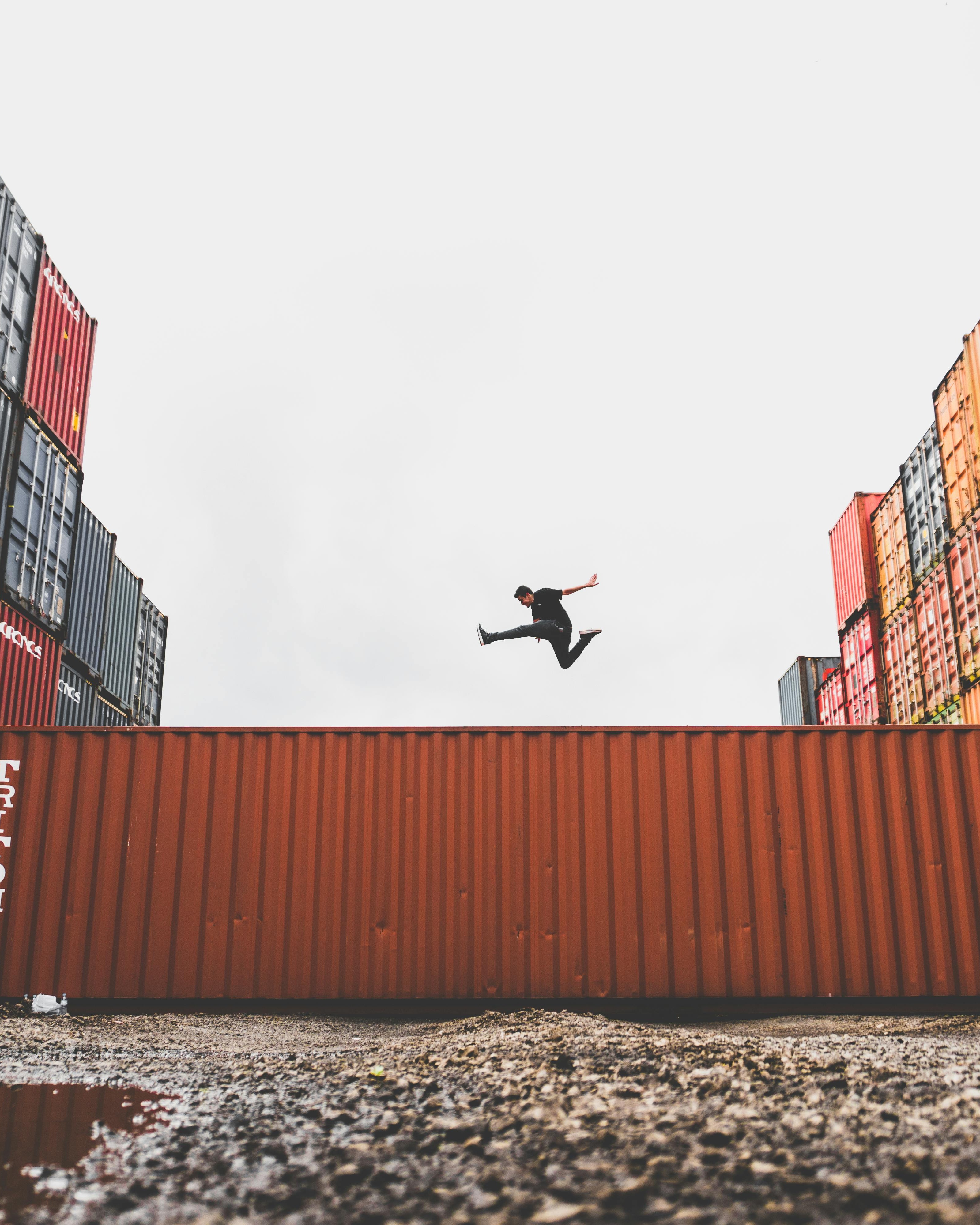 Man Jumping Over Shipping Container