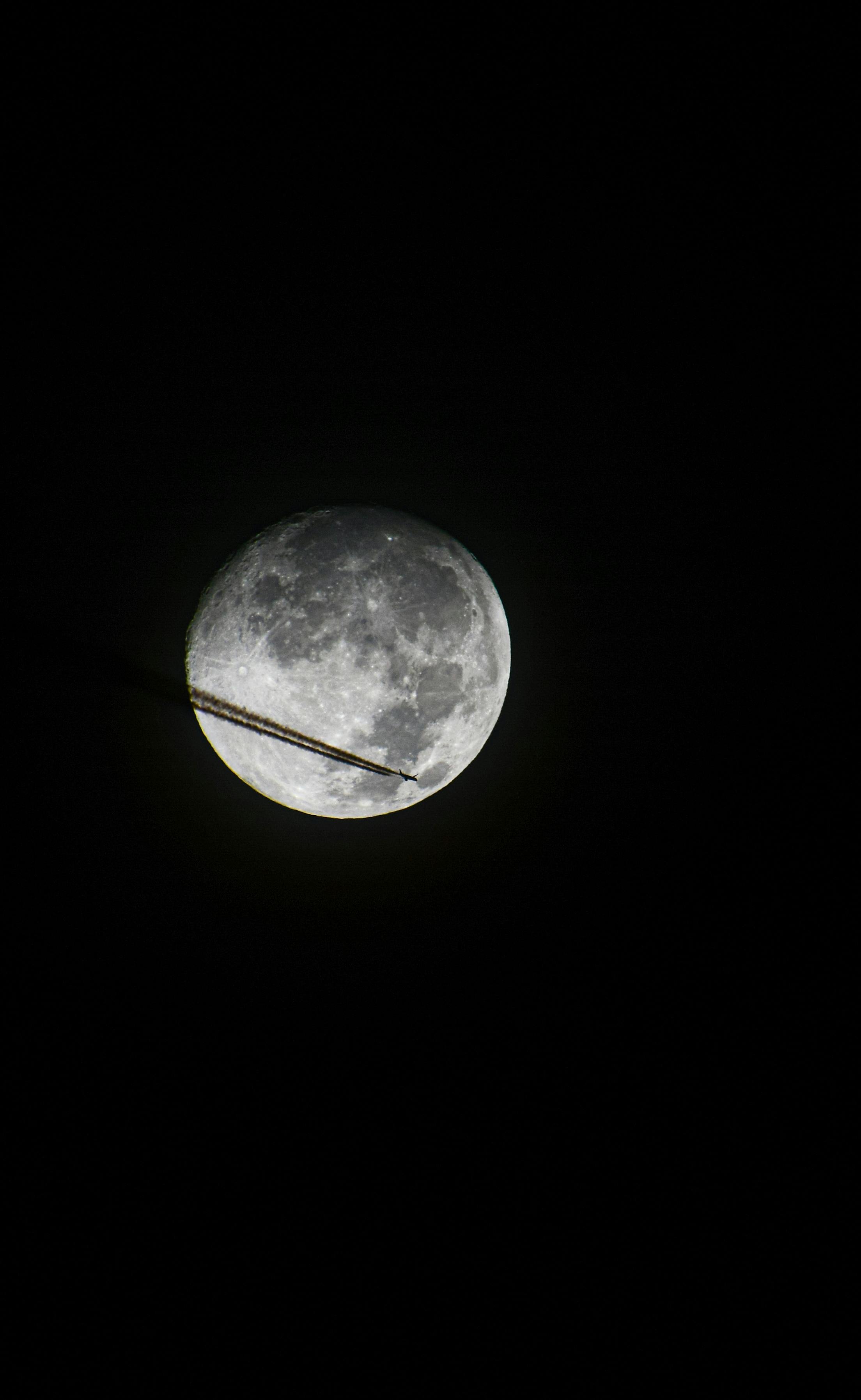 Airplane Crossing Full Moon