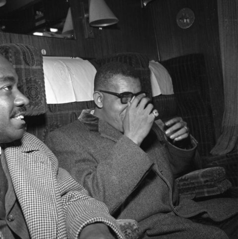 Two Black Men In Train Compartment