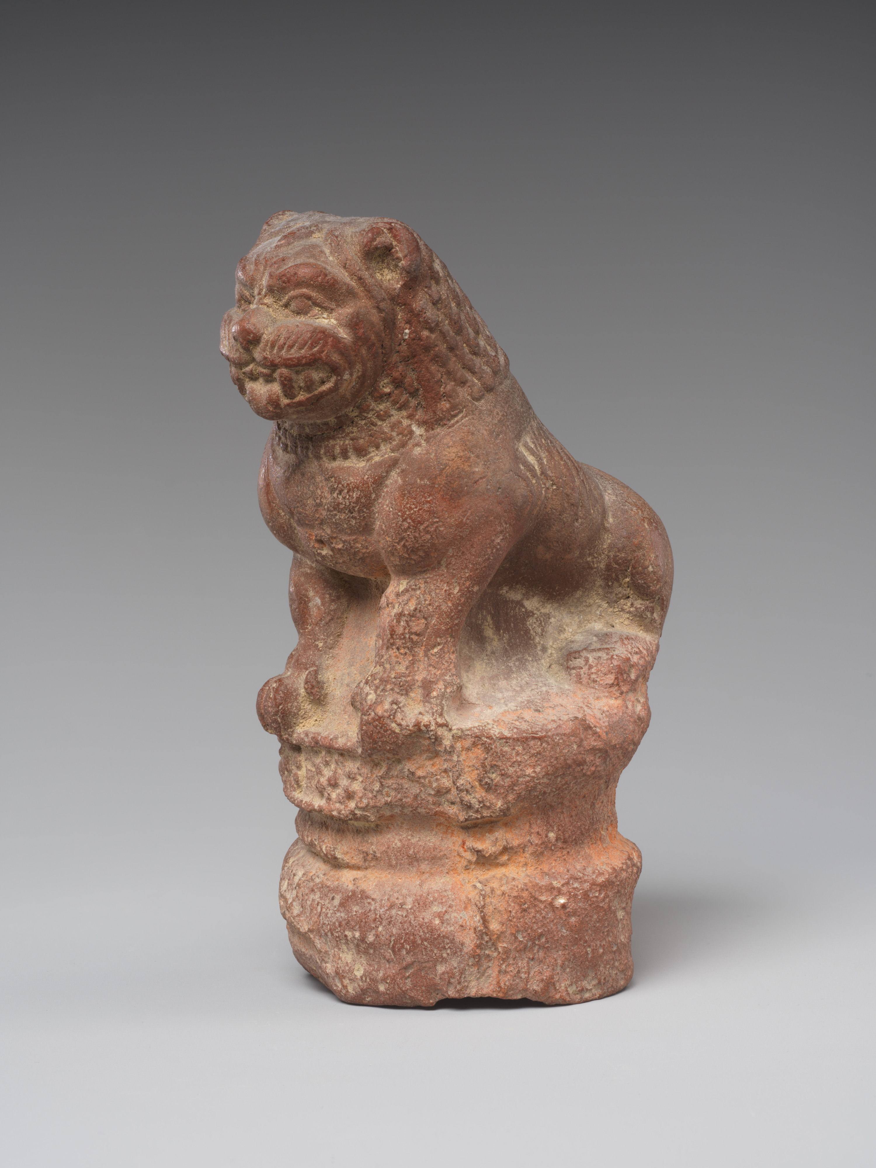 Red Stone Carved Seated Lion