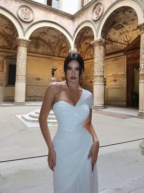 Woman in White Gown in Historic Courtyard