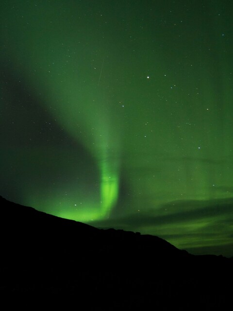 Green Aurora over Dark Hills