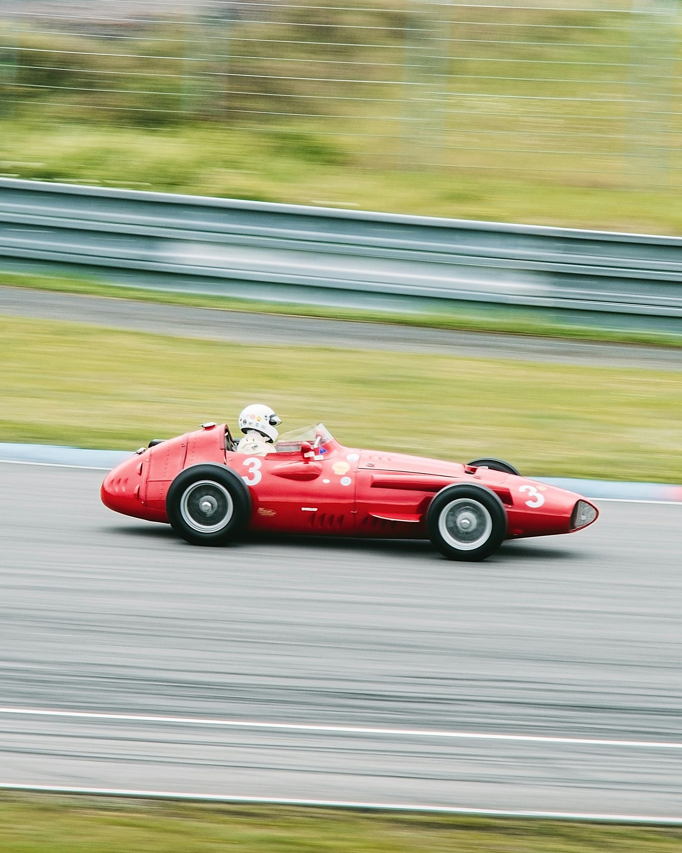 Vintage Red Race Car Speeding on Track