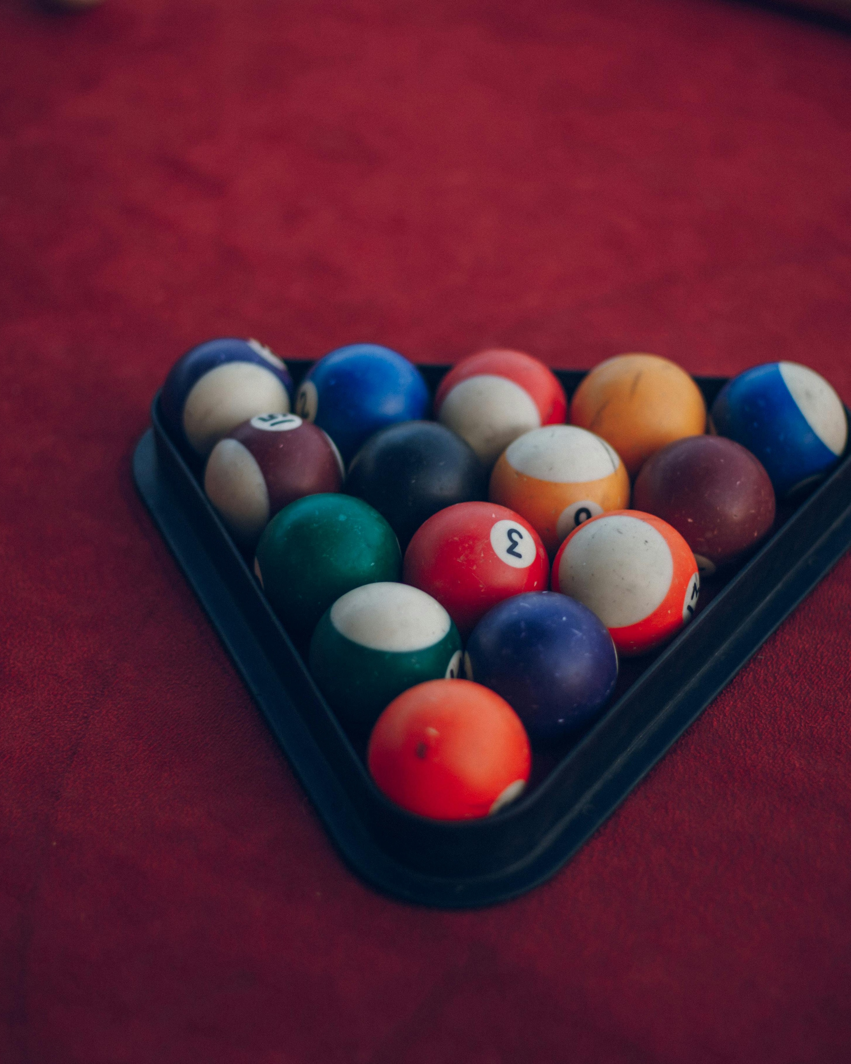 Racked Pool Balls on Red Pool Table