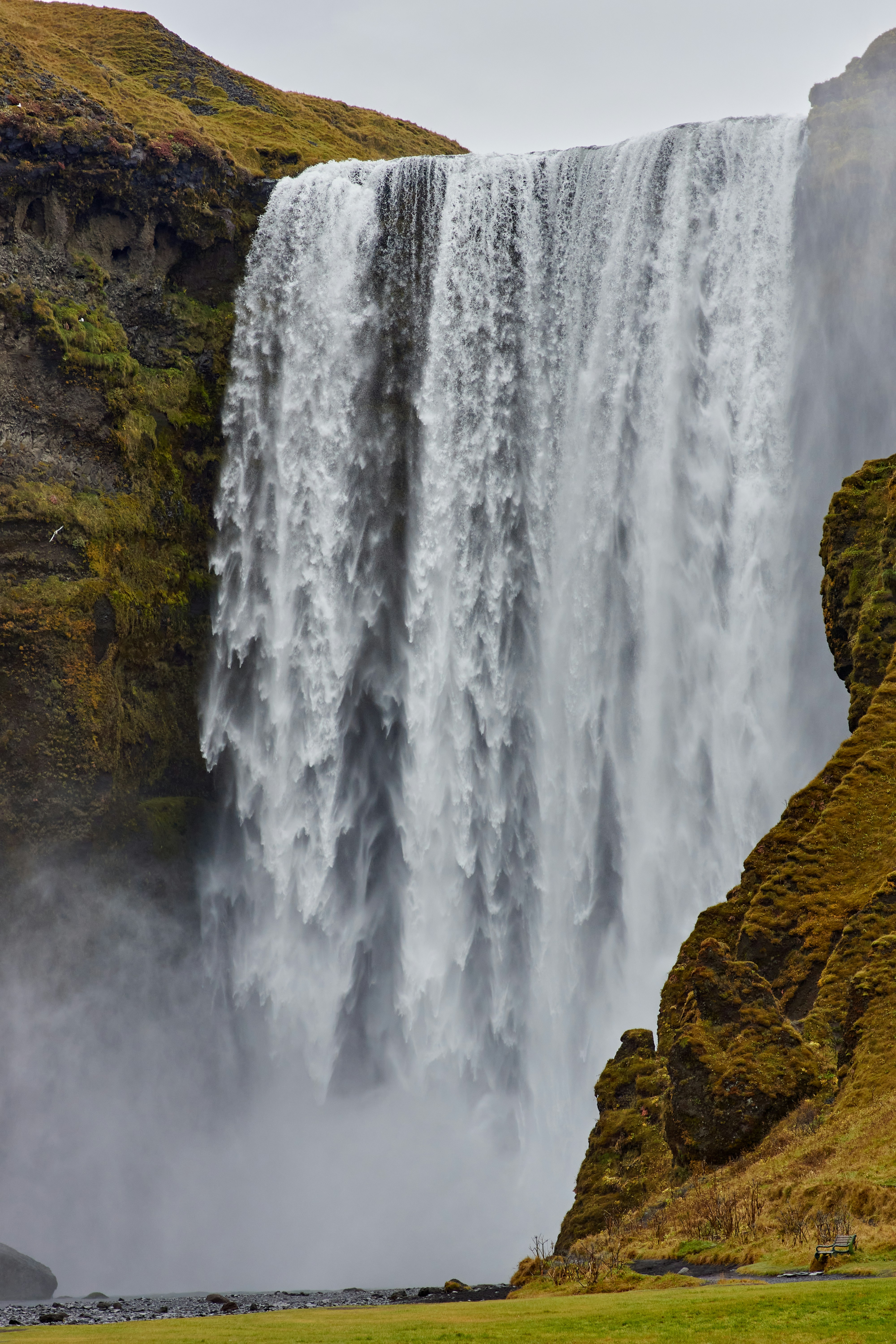 Massive Waterfall Between Mossy Cliffs