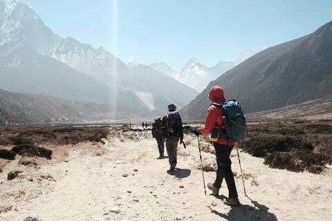 Trekkers Hiking in High Mountain Valley