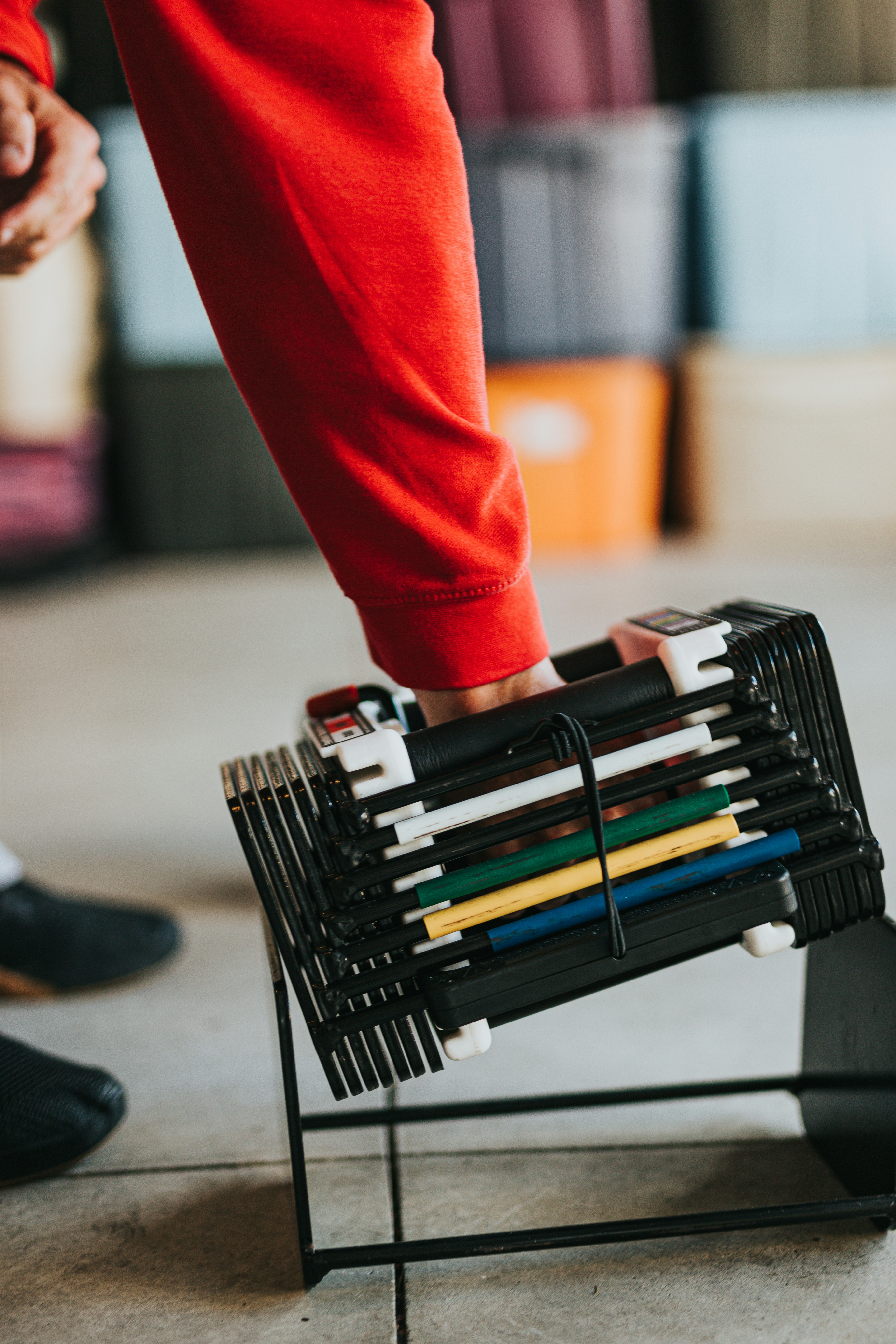 Person Reaching For Folded Gym Equipment