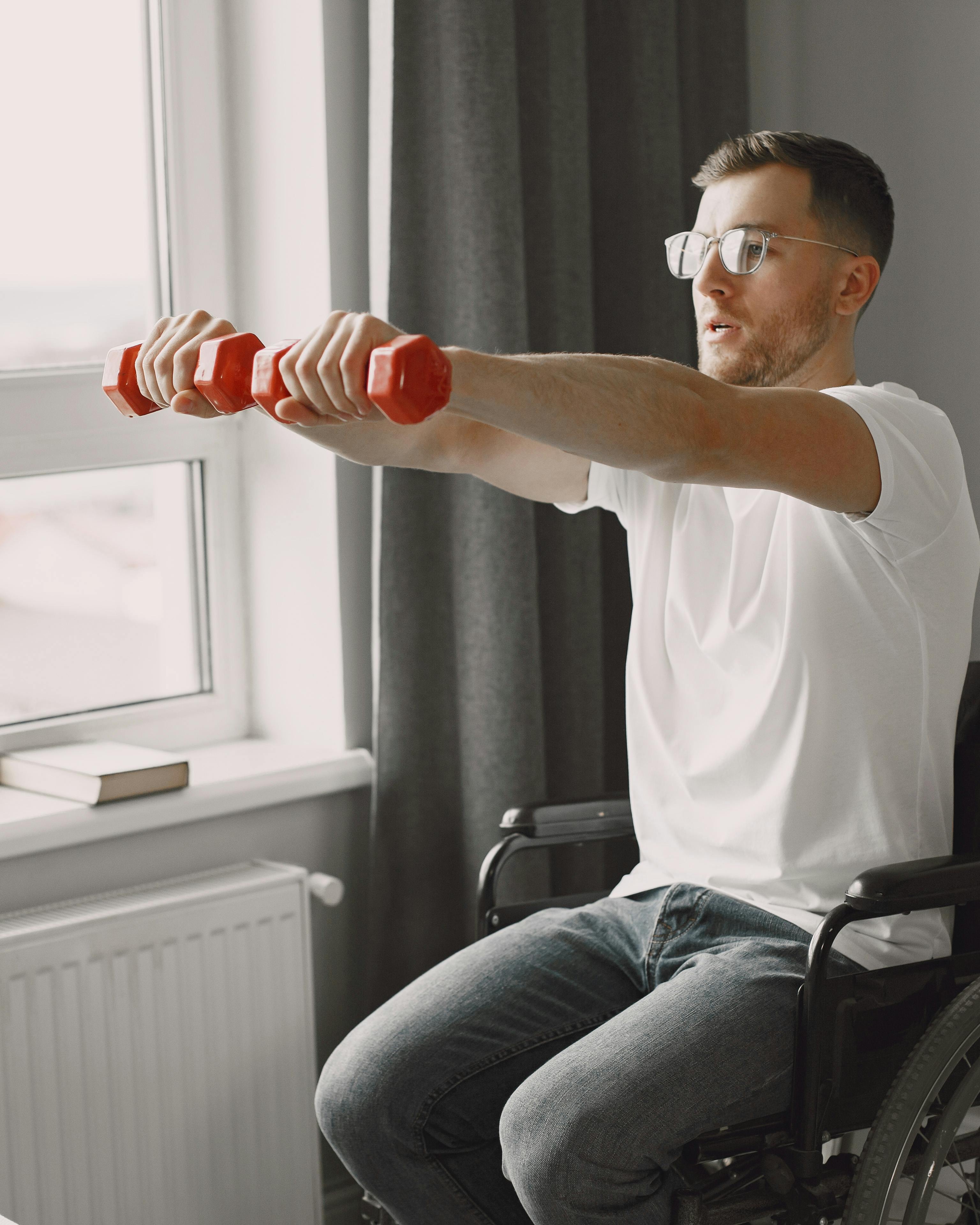 Wheelchair User Exercising With Dumbbells