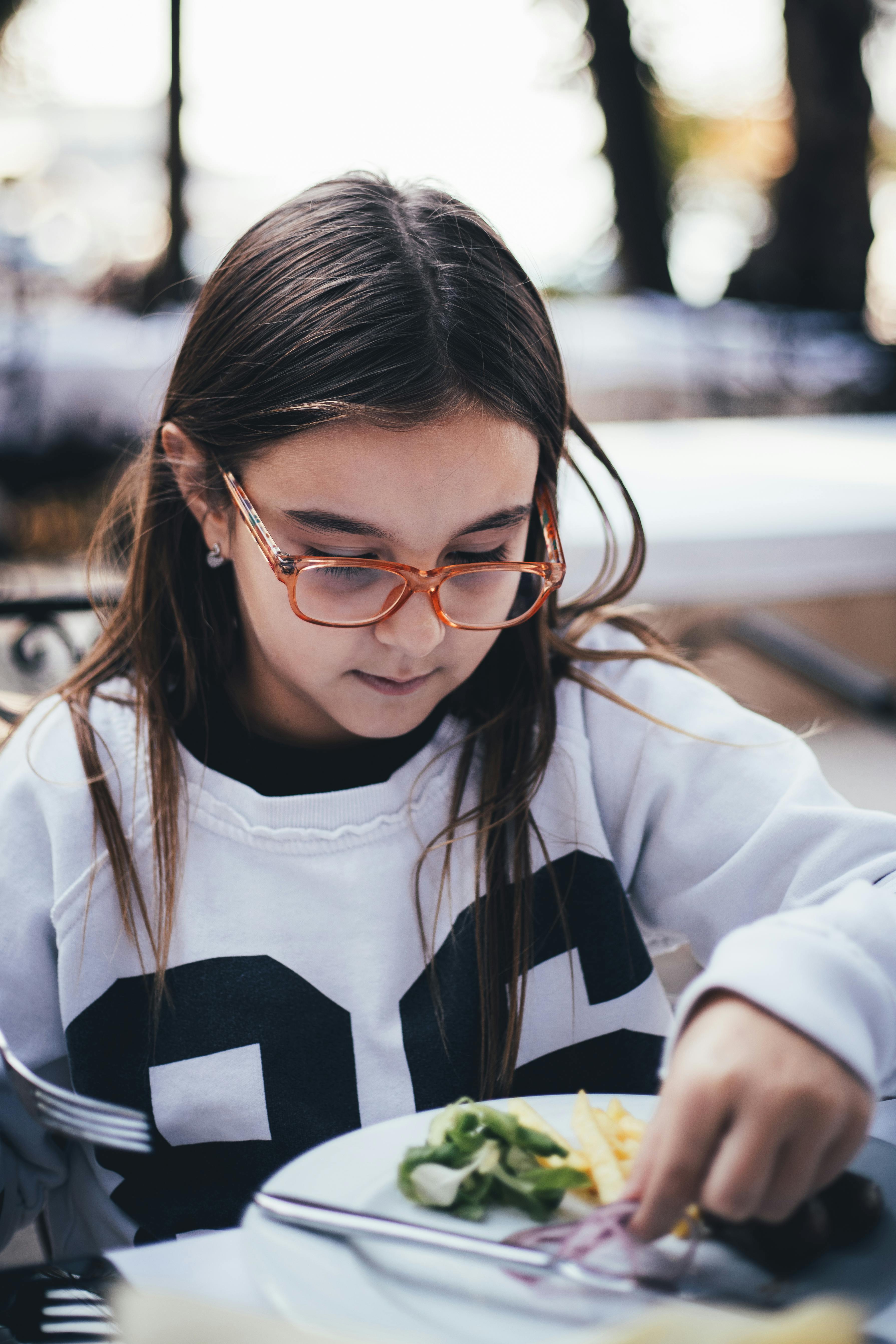 Girl Eating Meal Outdoors