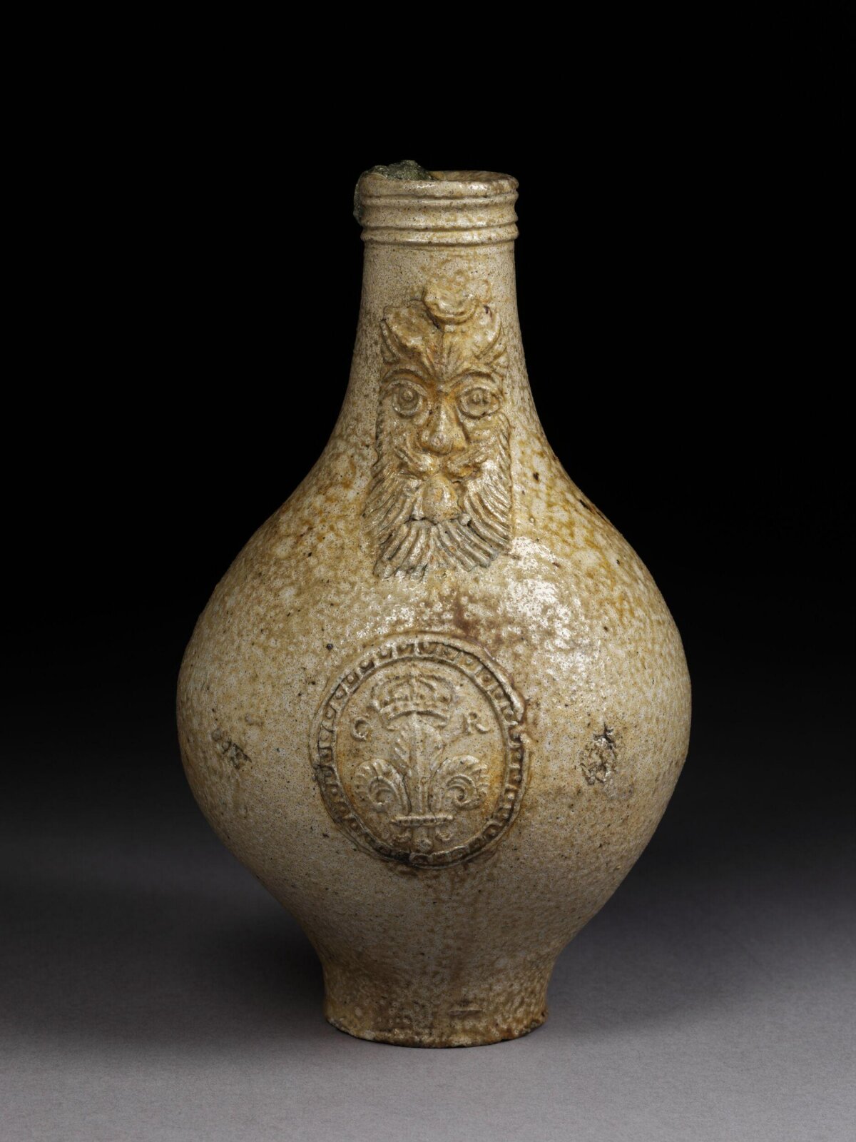 Antique Masked Stoneware Bottle