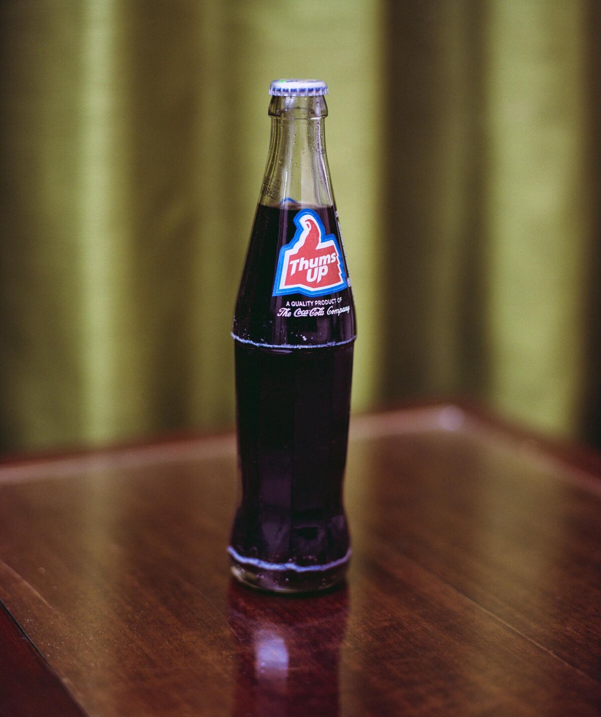 Thums Up Soda Bottle on Wooden Table