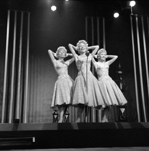 Three Singing Dancers Performing on Stage