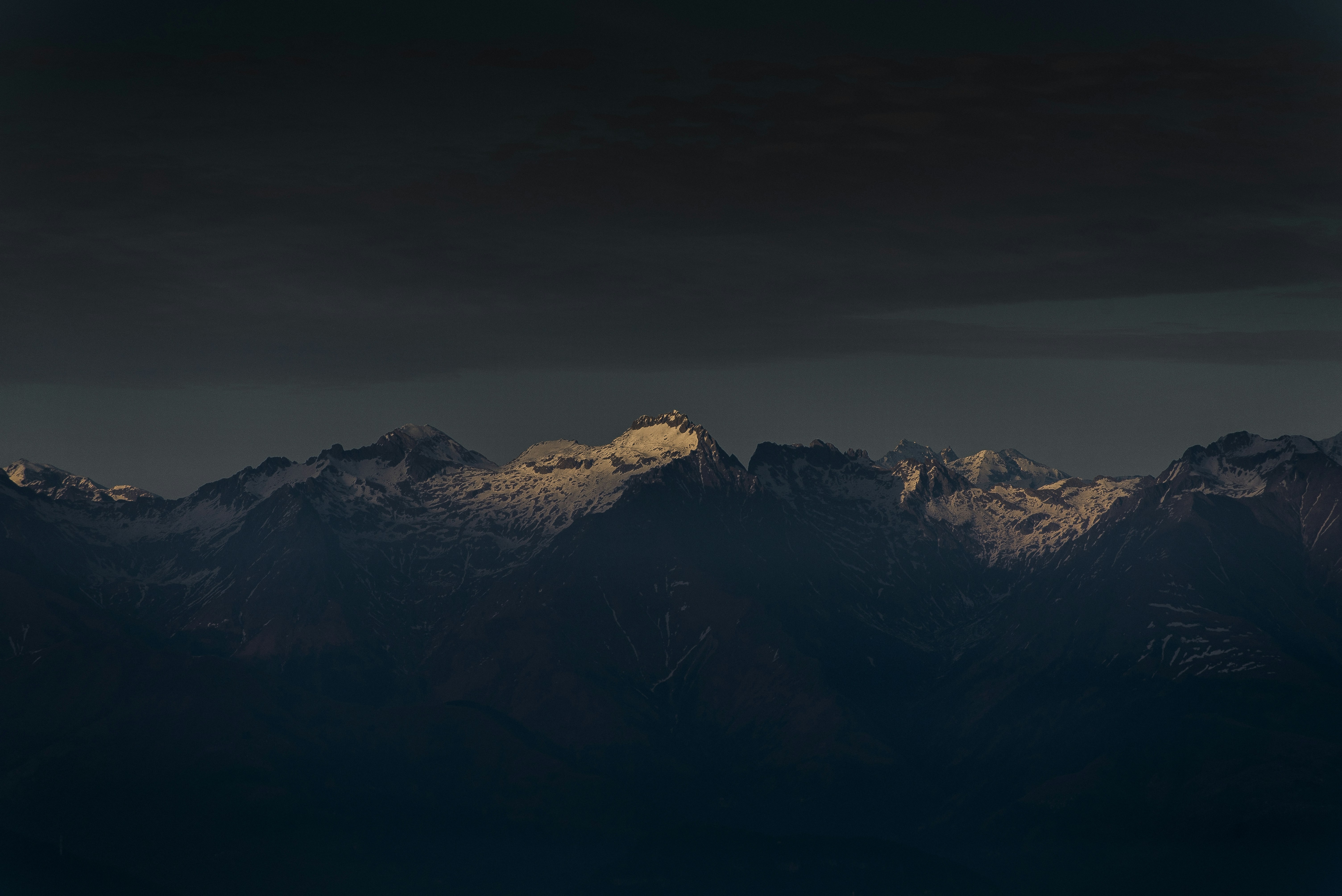 Sunlit Snow-capped Mountain Range