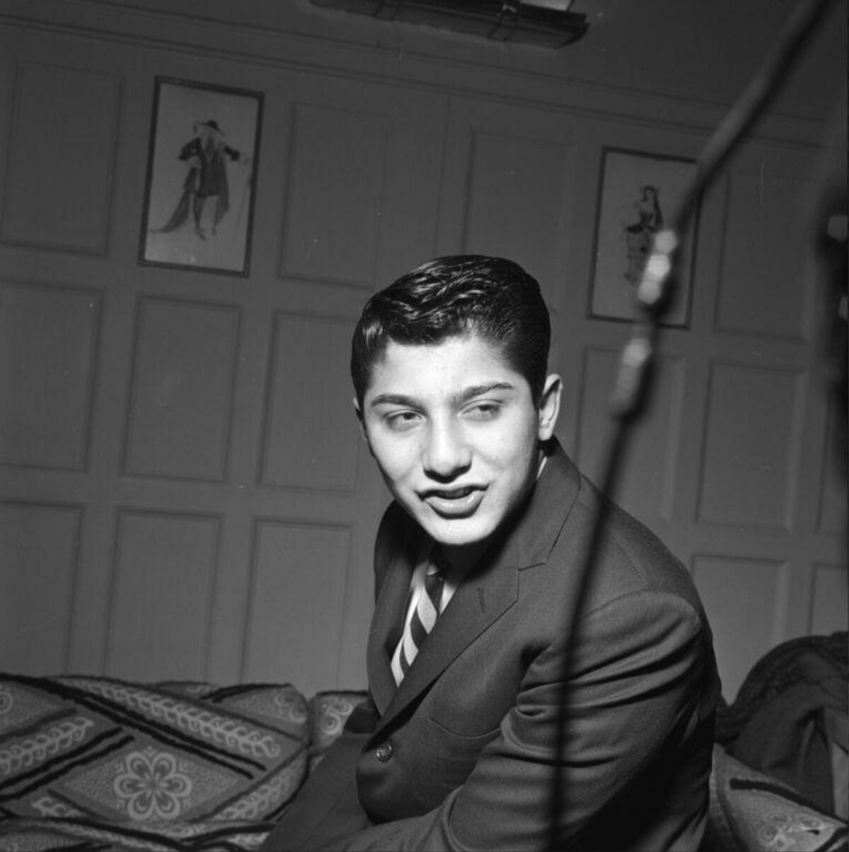 Young Man In Suit Seated On Couch
