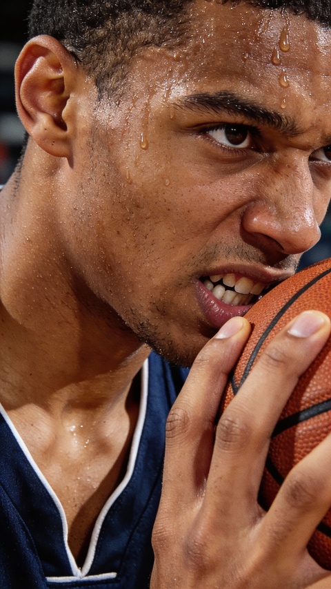 Sweaty Basketball Player Holding Ball