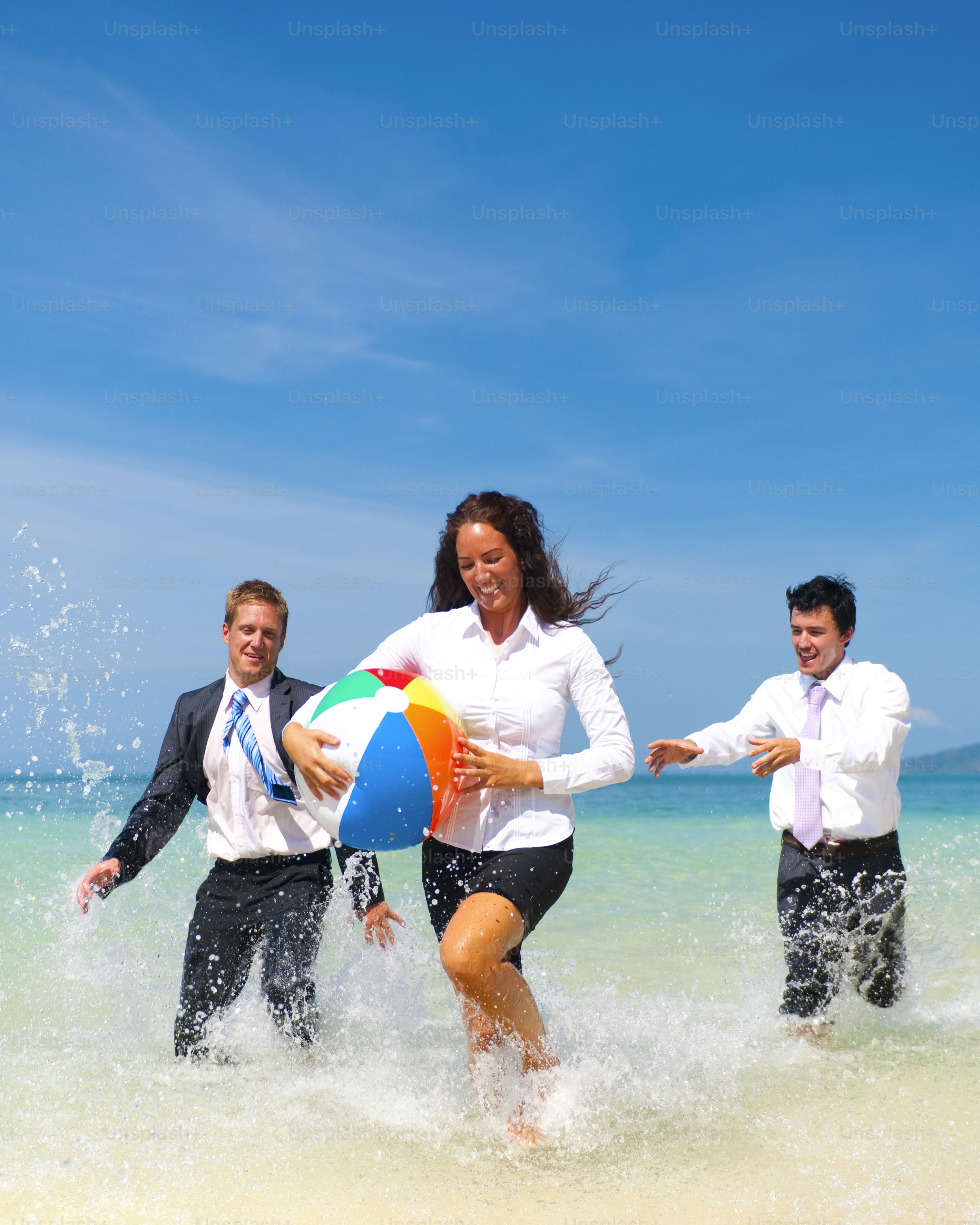 Business People Playing Beach Ball on Beach
