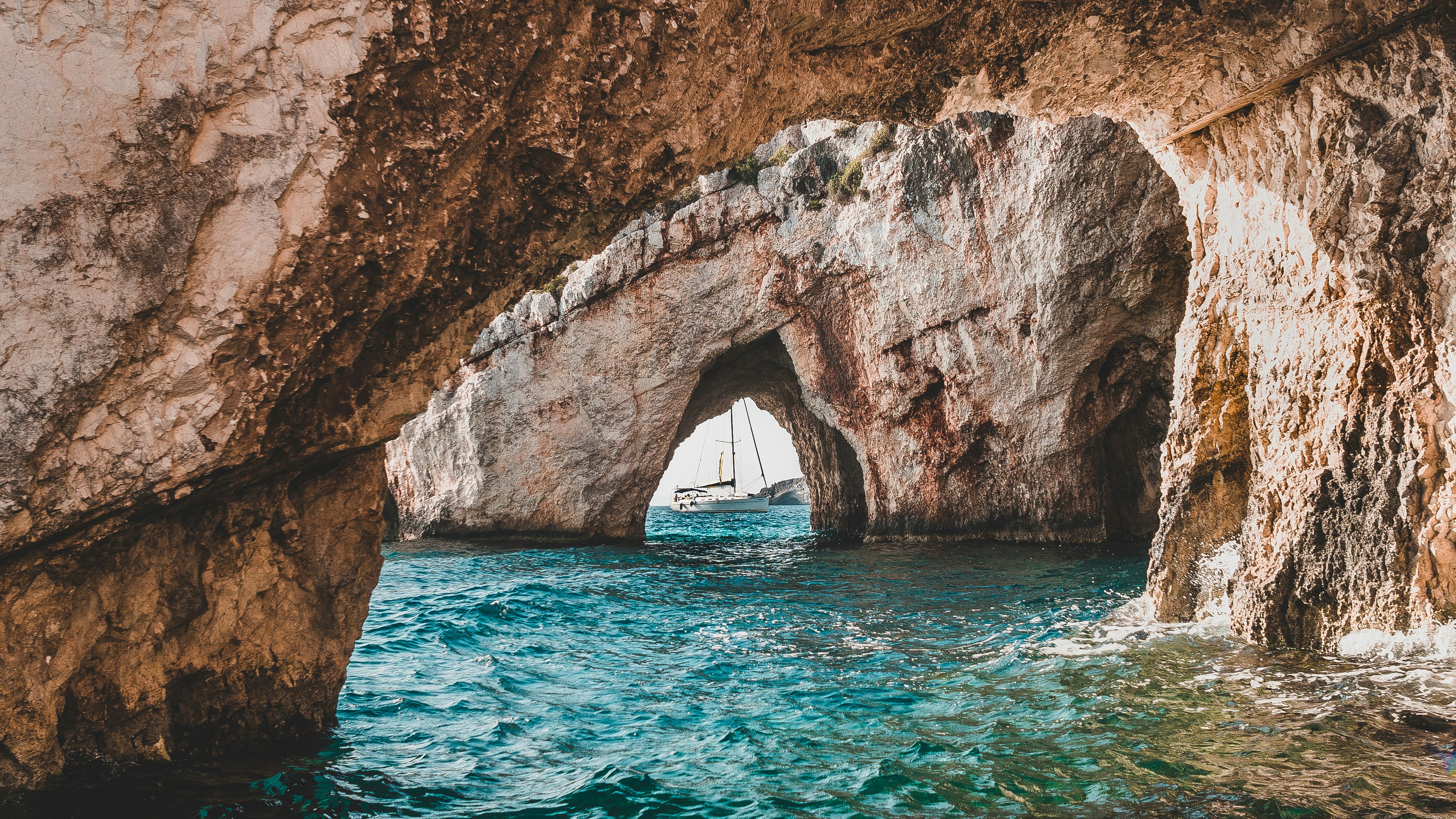 Coastal Sea Cave With Sailboat