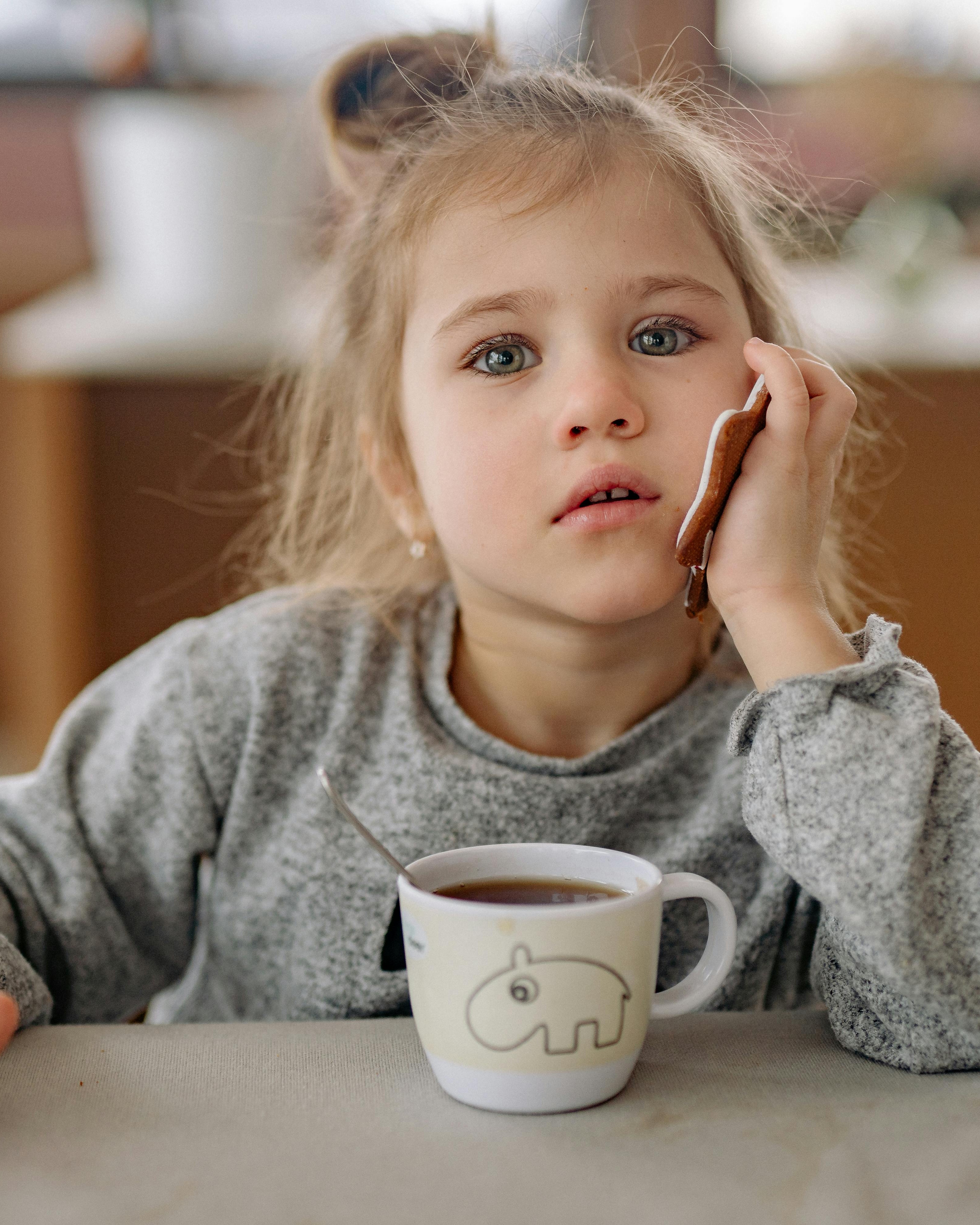 Little Girl Pretending Call With Cookie