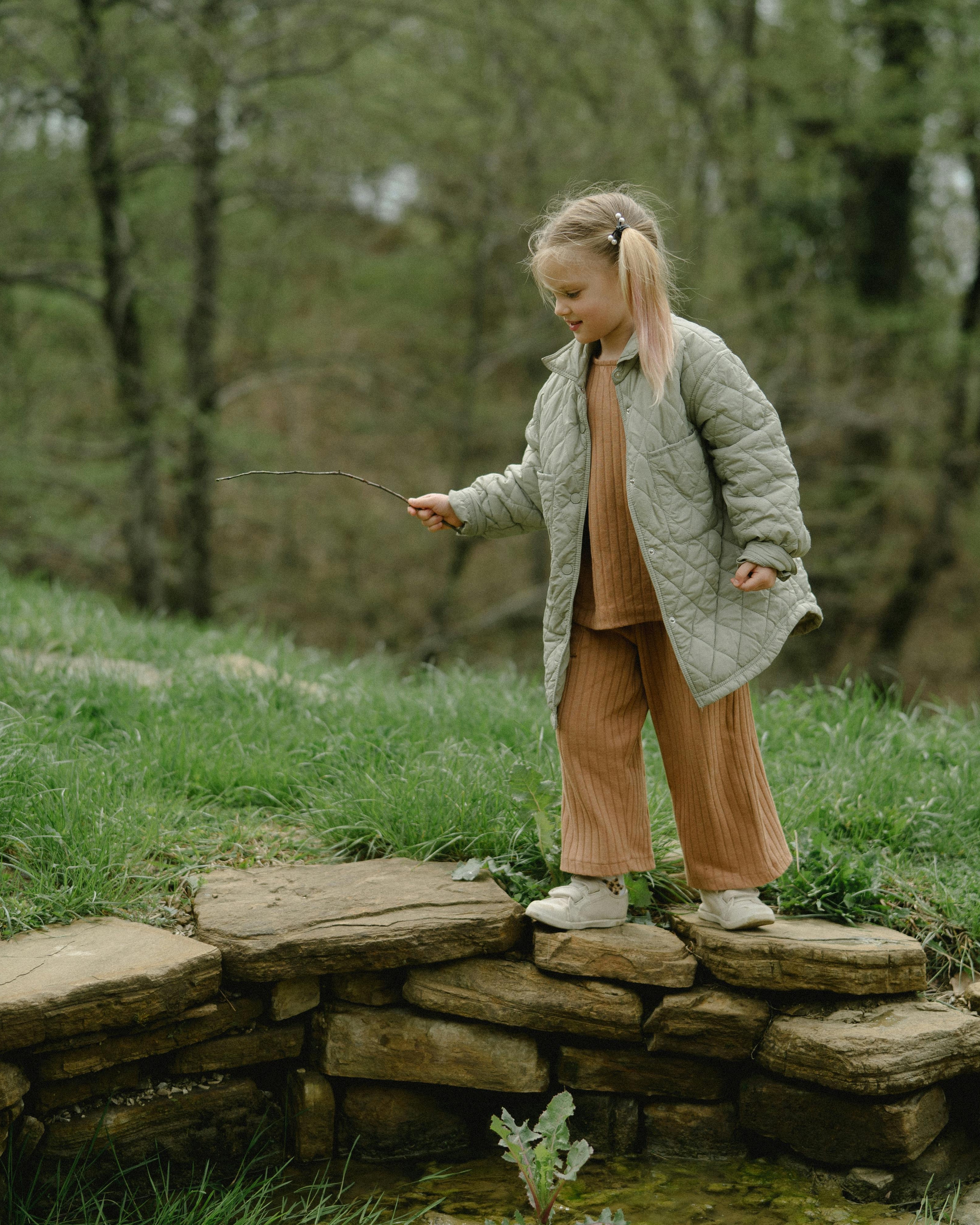 Little Girl Exploring Outdoors by Stream
