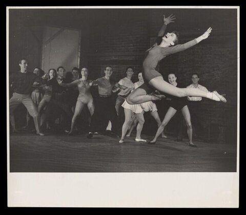 Dancer Leaping During Group Rehearsal