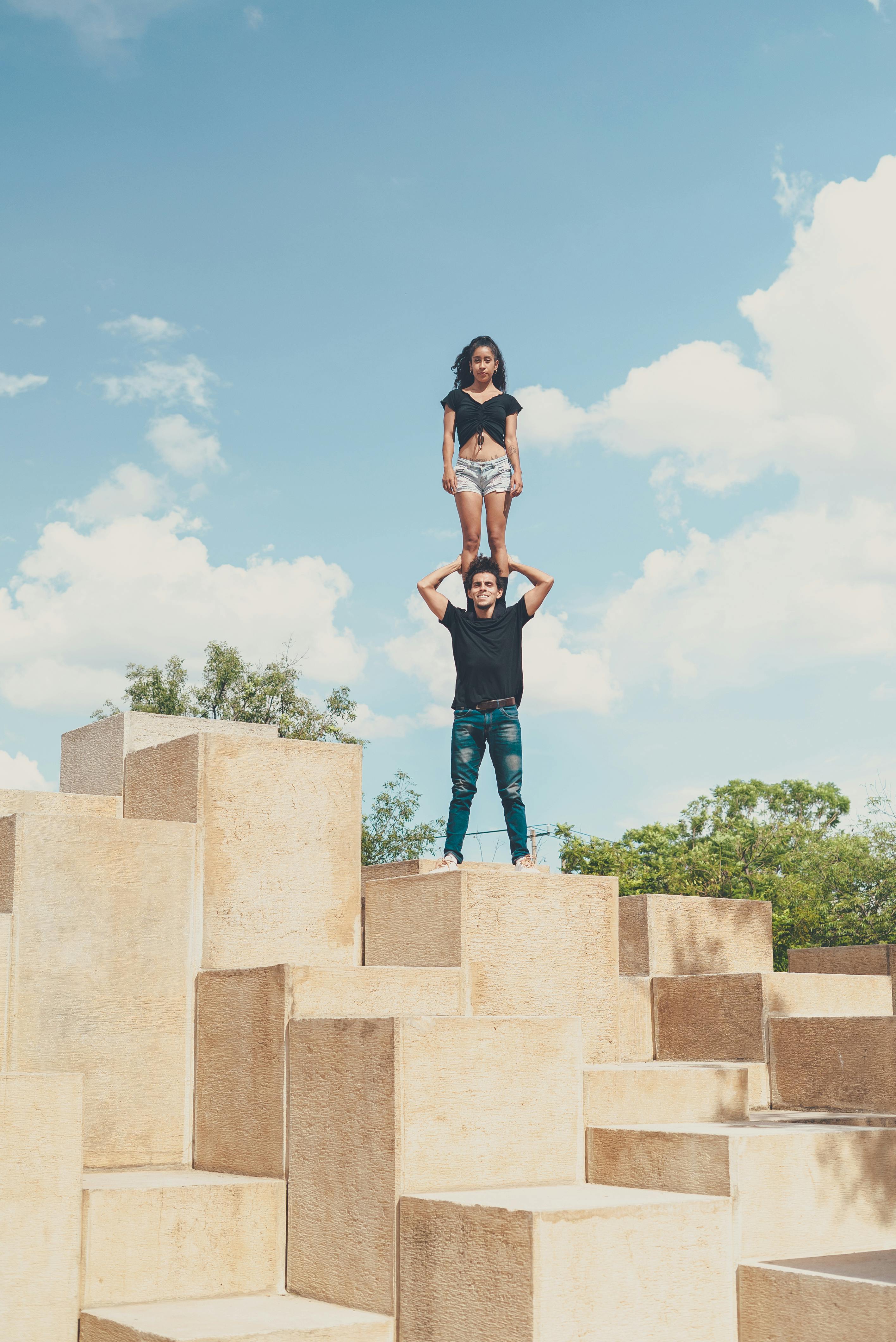 Couple Balancing On Stepped Stone Blocks