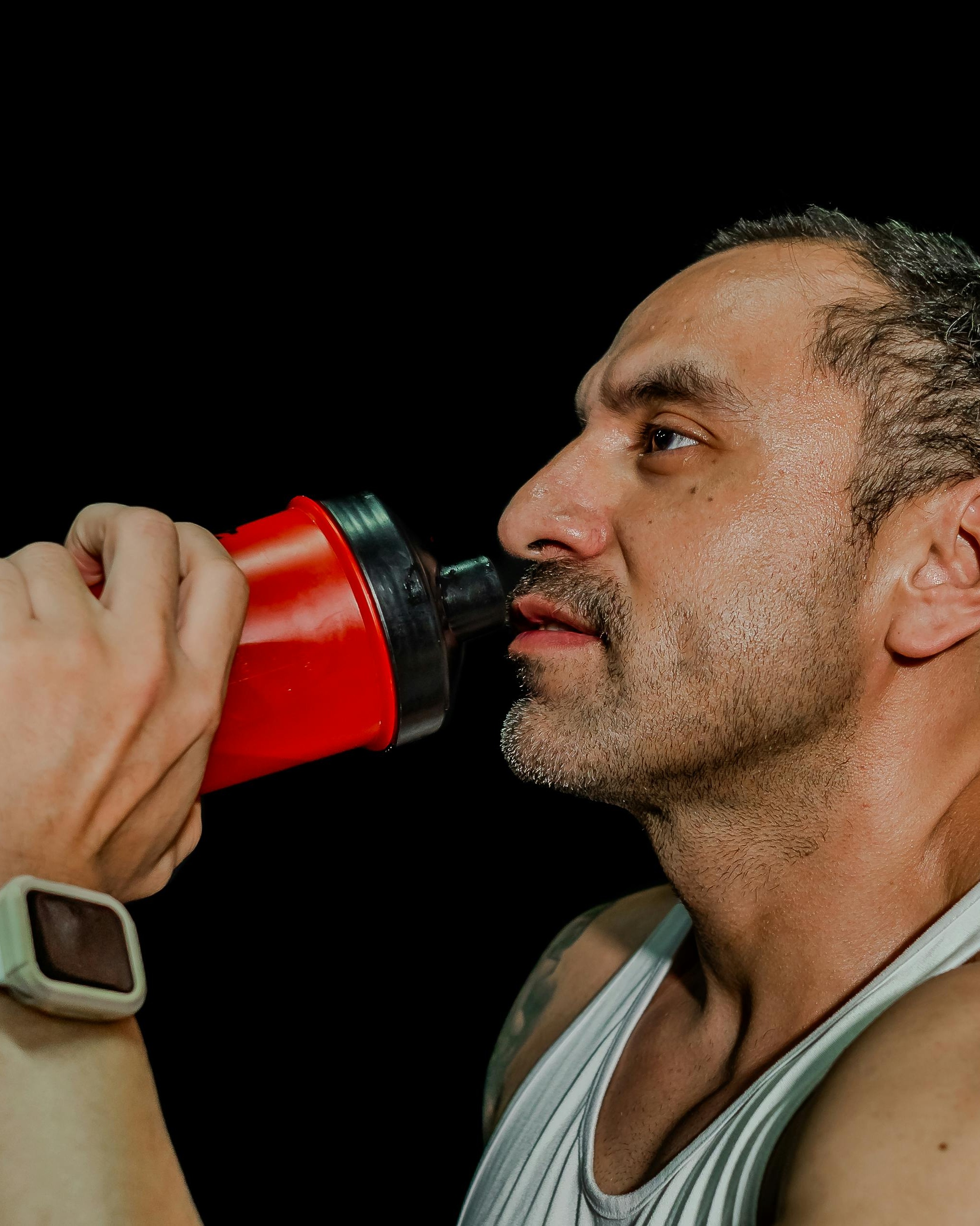 Sweaty Man Drinking Protein Shaker