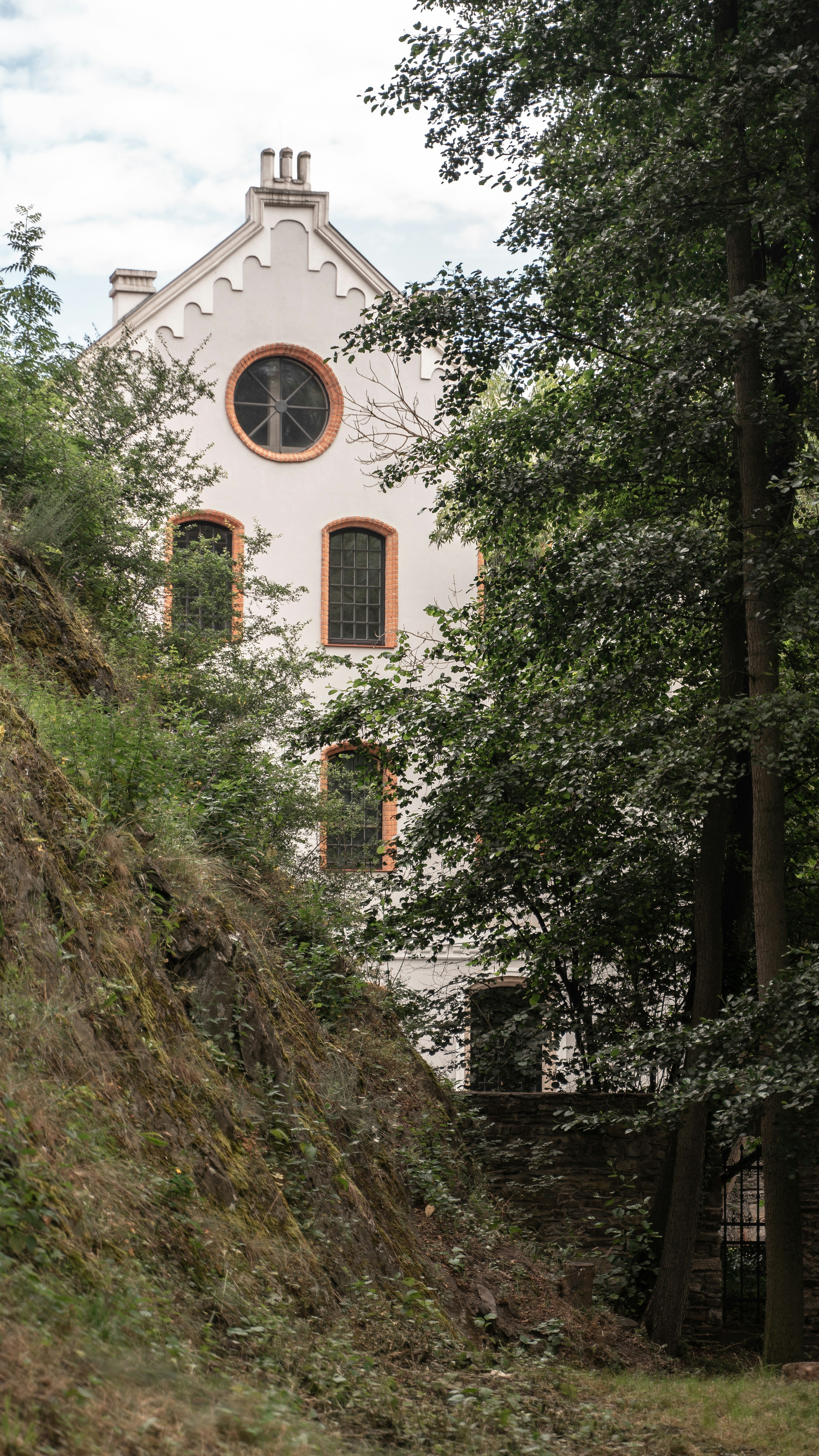 White Gabled Building Among Trees